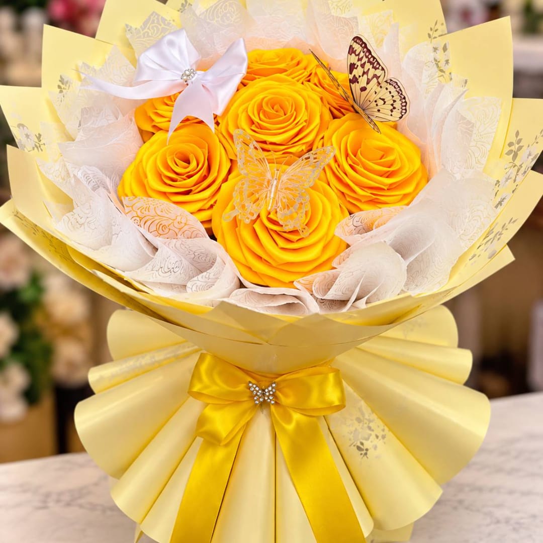 Yellow rose bouquet with butterfly decorations and a satin bow