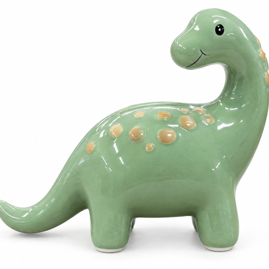 Green ceramic dinosaur figurine with yellow spots on a white background