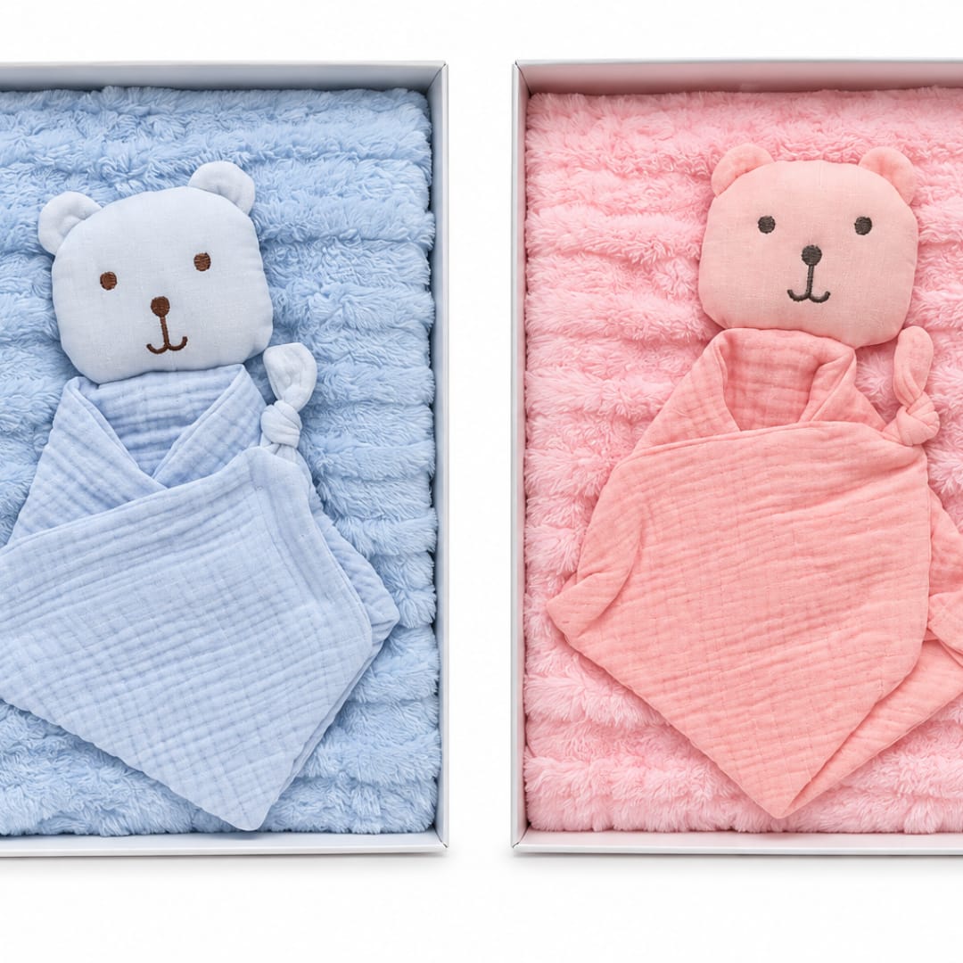 Two boxed baby blankets with teddy bear faces, one blue and one pink