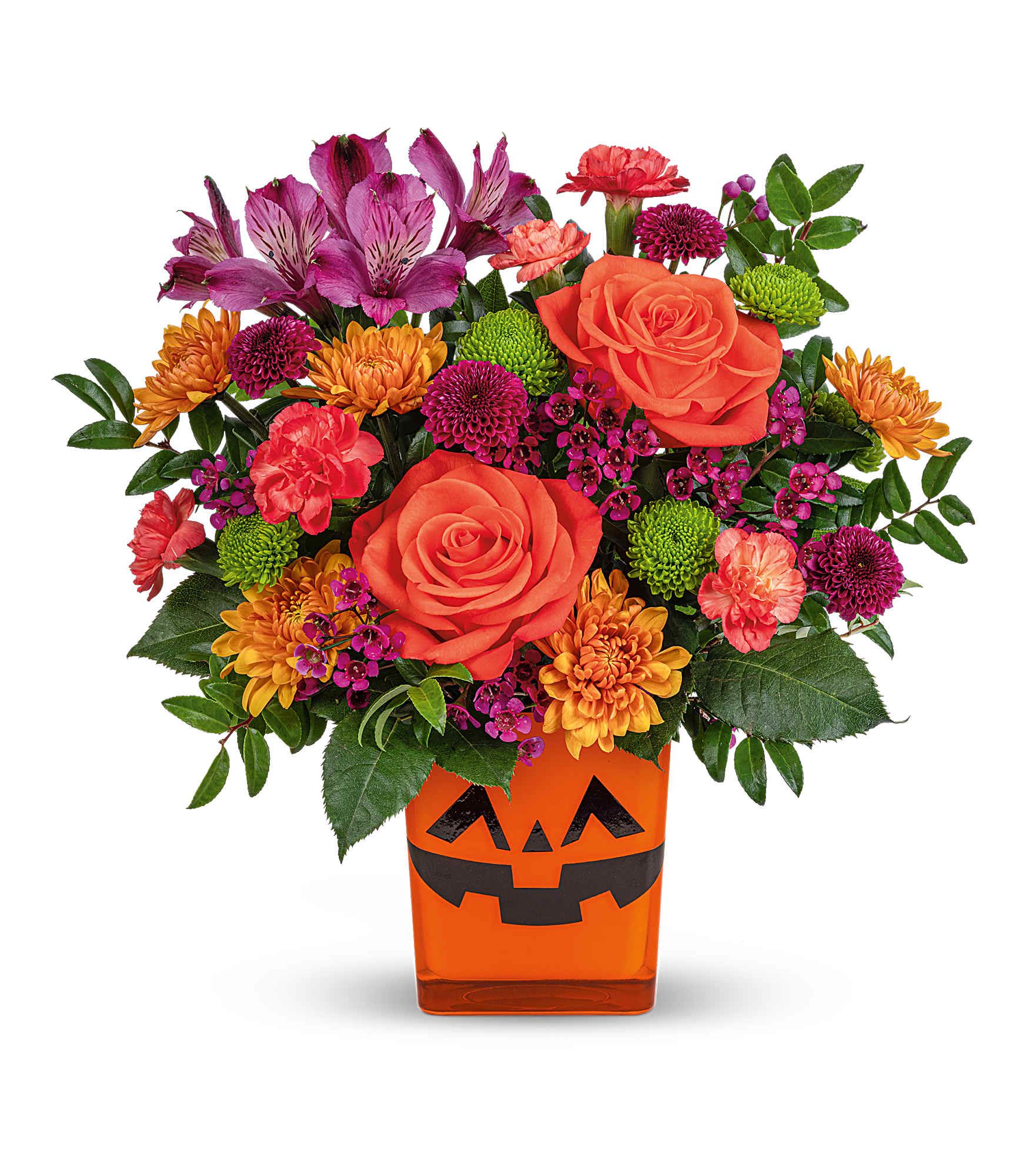Spooky Spectacle Bouquet - Spooky Spectacle Bouquet is a Halloween treat! Bright orange roses, colorful mums, and a fun jack-o'-lantern face light up Teleflora's Coral Color Splash Cube. A cheerful pumpkin-themed gift for spooky celebrations.