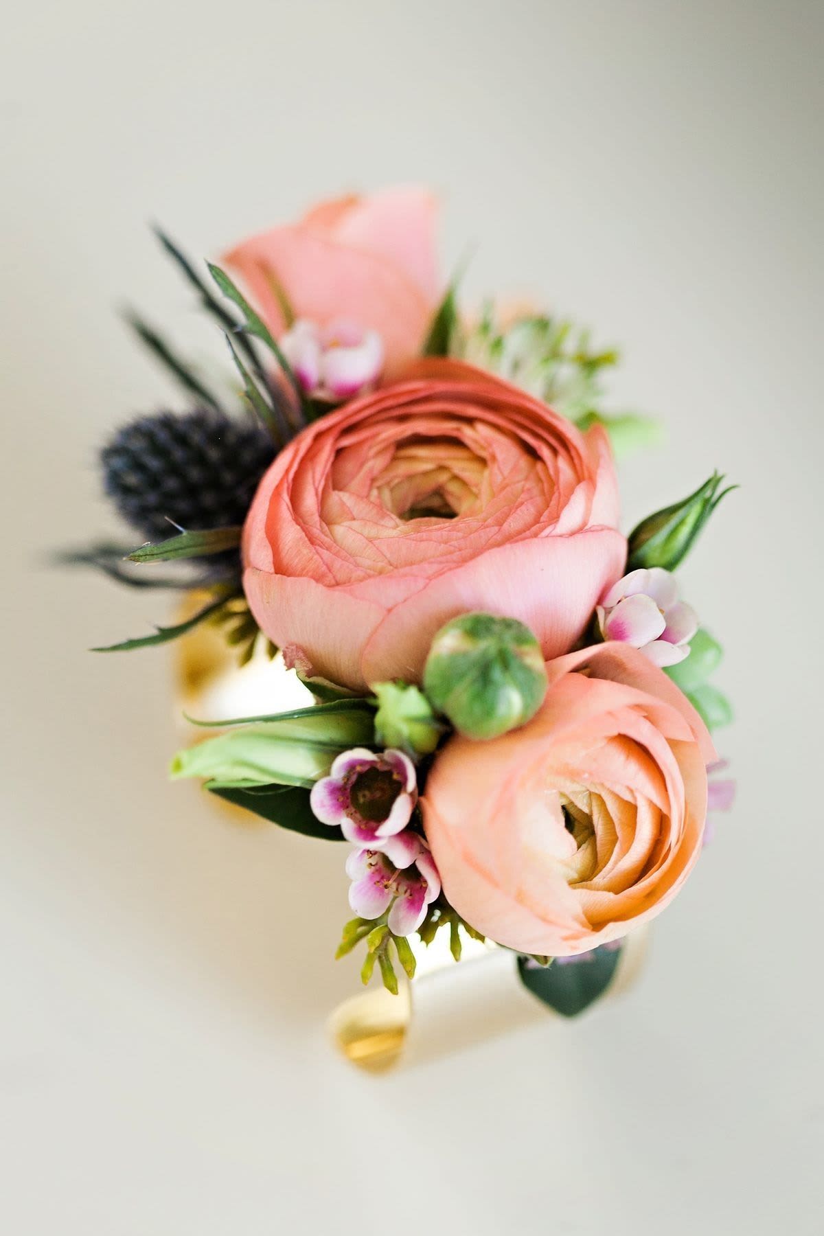 Small bouquet of peach ranunculus and tiny pink flowers