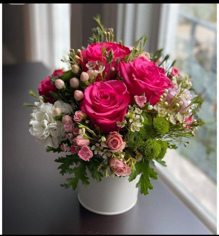 Pink Crush - A lush, romantic arrangement featuring vibrant hot pink roses surrounded by soft blush blooms, delicate waxflower, and fresh green accents.