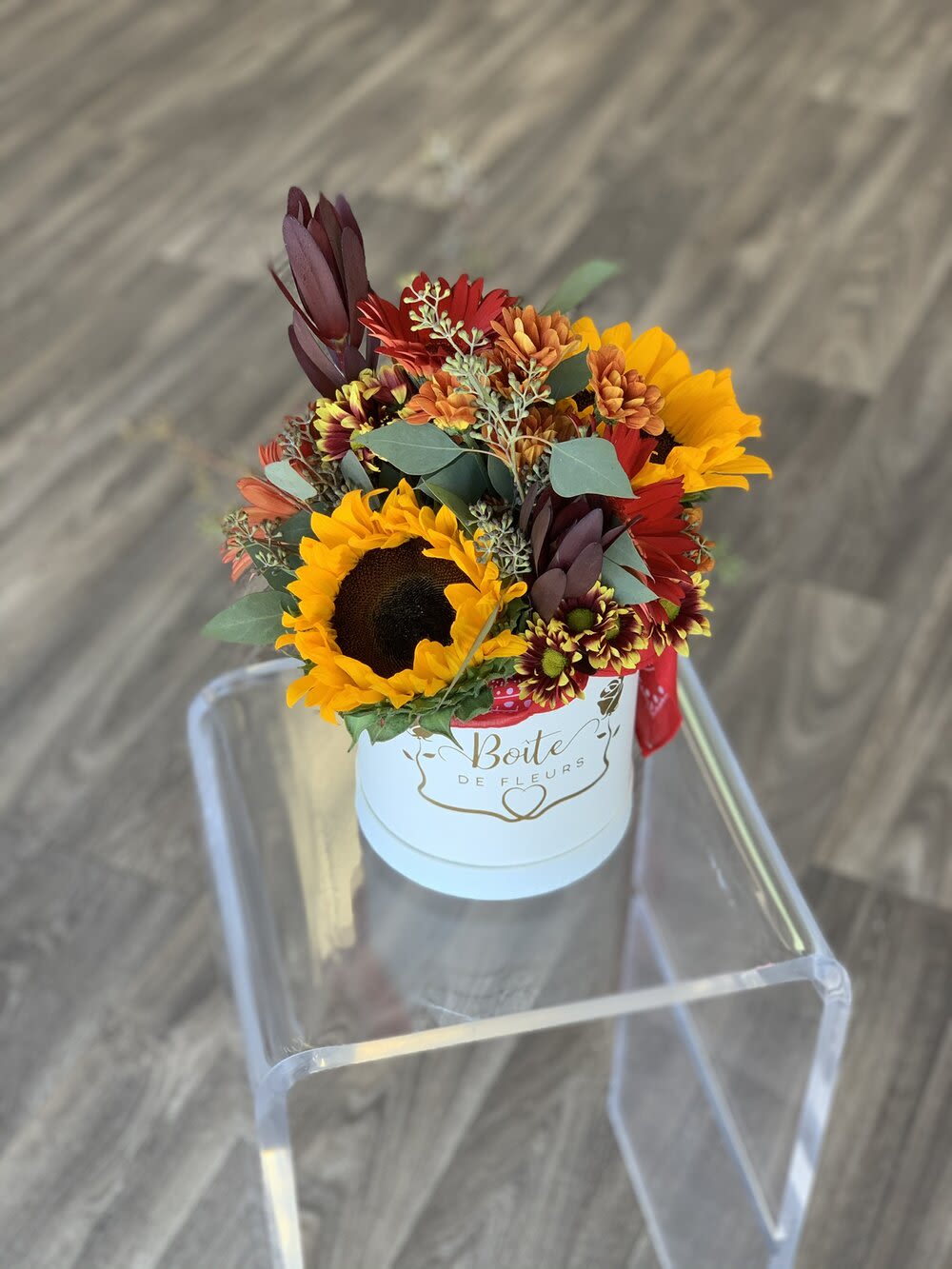 Sunflowers and mixed autumn flowers in a white hat box