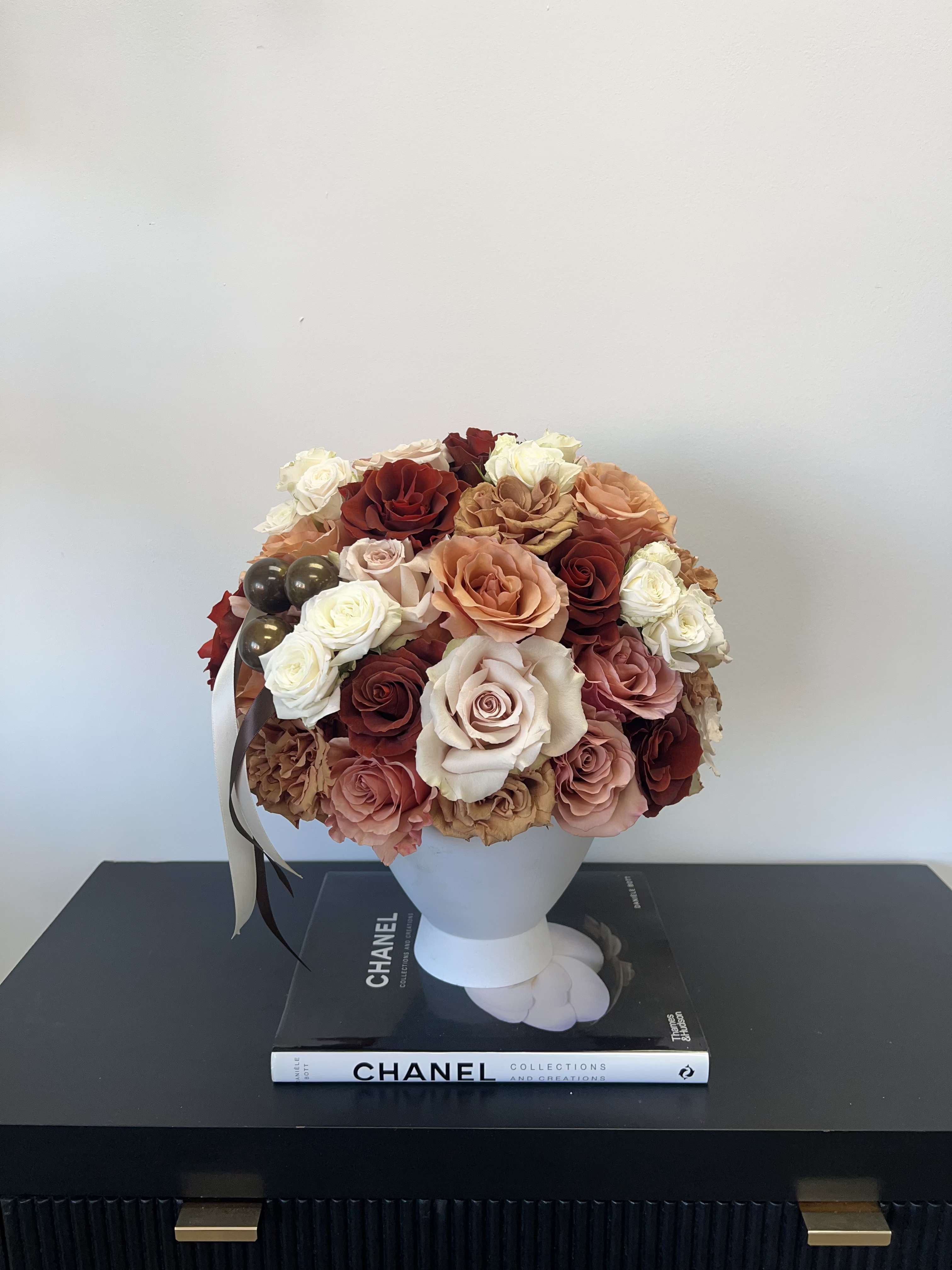 Cashmere Kiss  - Cashmere Kiss is a luxurious rose arrangement featuring elegant shades of brown, ivory, cream, and soft neutrals. Handcrafted with premium long-lasting roses, this timeless flower arrangement makes the perfect gift for an anniversary, birthday or just because. Elevate your space with this neutral floral arrangement.
