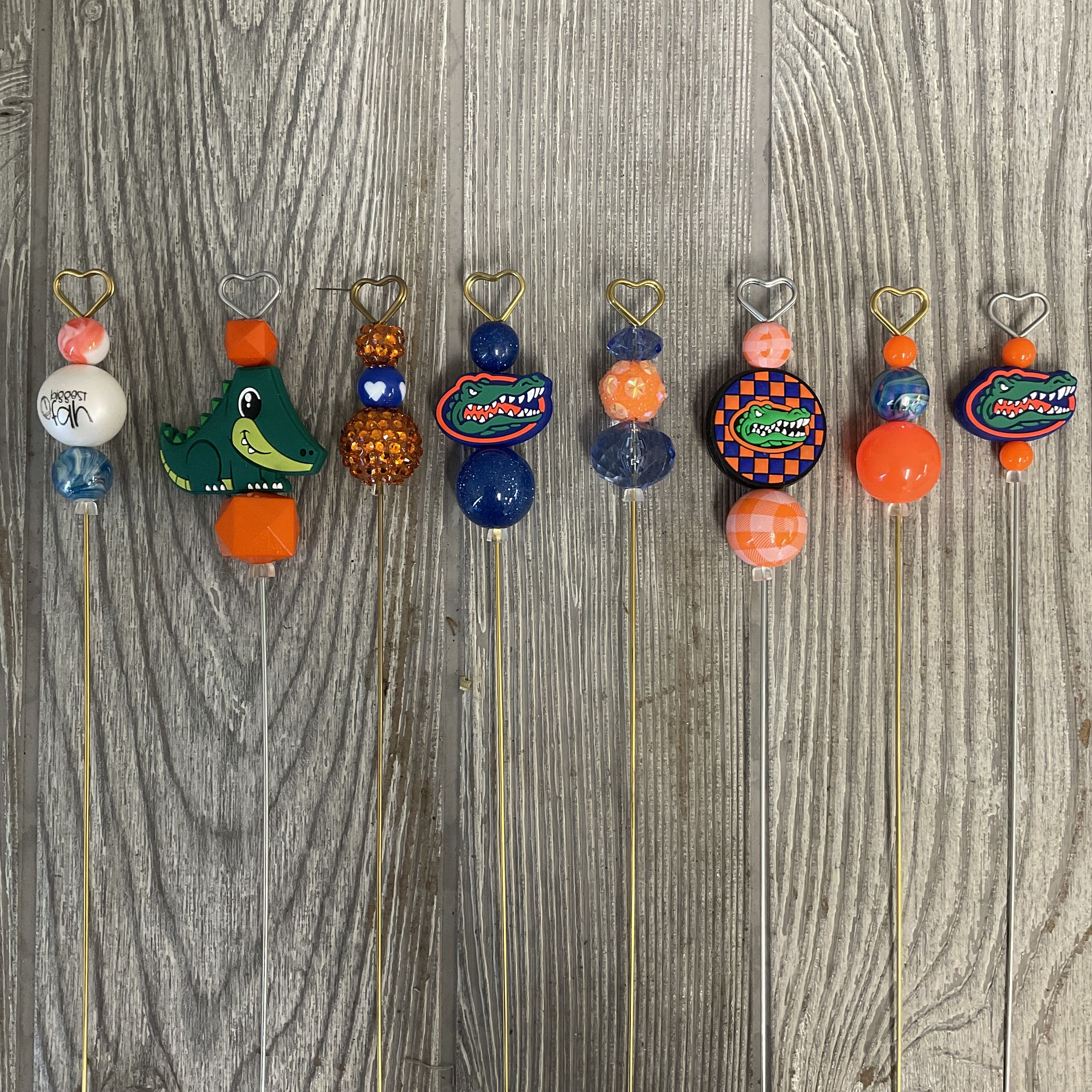 Decorative beaded picks with heart toppers and Florida Gators charms