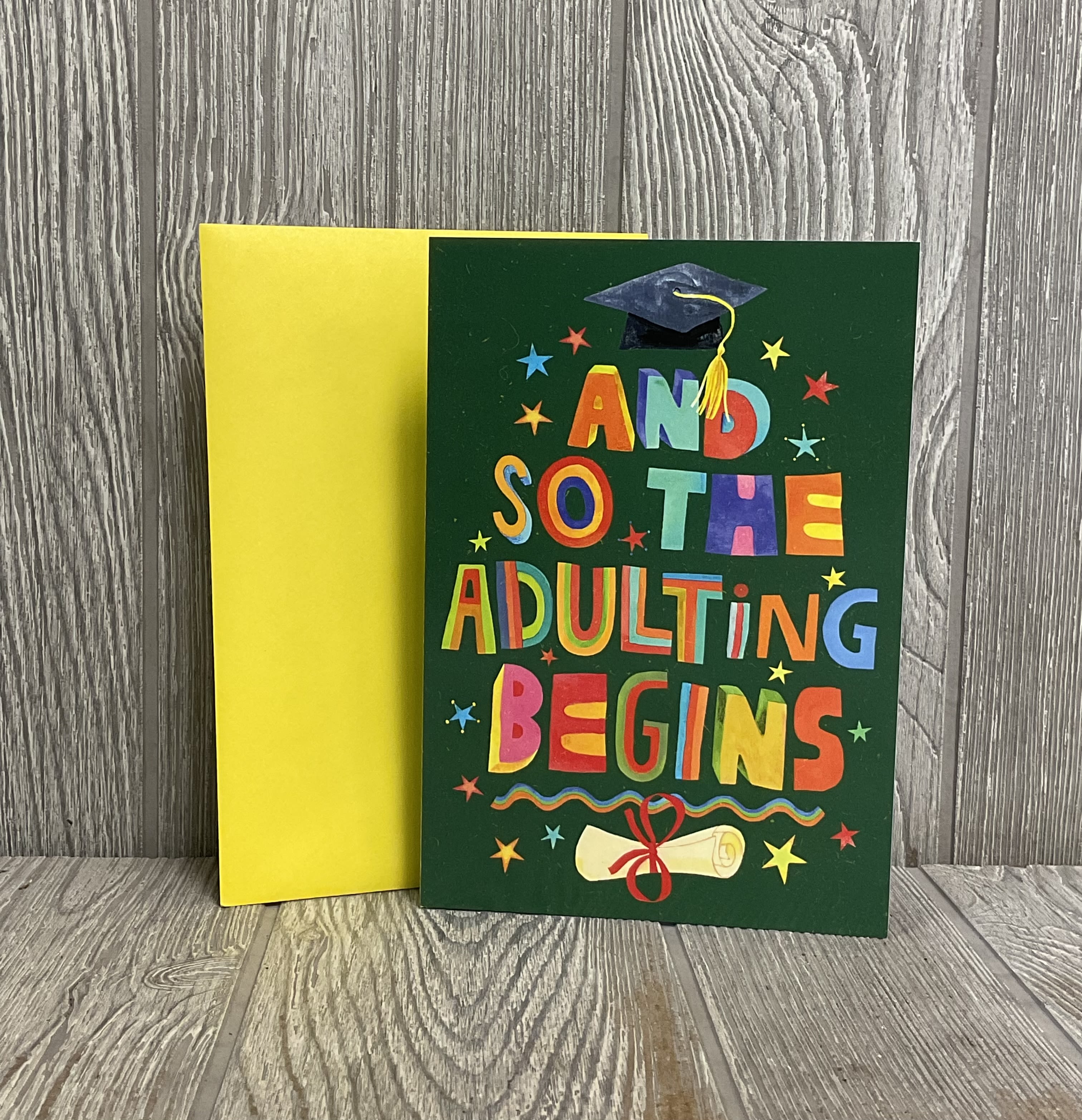 “And So The Adulting Begins” Full Sized Graduation Greeting Card - Card will be delivered approximately as pictured. 