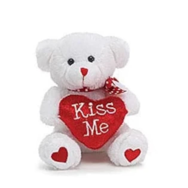 Lovable Vase Hugging Bear by Burton &amp; Burton - A sweet, cuddle-ready accent for Valentine's Day or any romantic occasion, this lovable vase-hugging teddy bear brings instant charm to a flower arrangement and says "I'm thinking of you" without words. The single white plush bear clasps a red heart-shaped pillow-available in three message varieties ("Hug Me," "Kiss Me," or "I'm Yours")-so the recipient will feel personally seen and adored. Its red nose, tiny black eyes and red heart accents on the feet create a playful, affectionate look that pairs naturally with roses or mixed bouquets for anniversaries, proposals, or just-because surprises.  The bear wraps around a standard vase, securing to the arrangement with a cheerful red polka-dot ribbon for a polished gift presentation. Crisp white plush contrasts with the bright red heart to keep the focus on both the flowers and the loving message; the soft texture and embroidered wording make it a keepsake long after the blooms fade. Ideal for anyone who appreciates a touch of whimsy-this piece turns a floral gift into a sweeter, more memorable moment.  Perfect for gifting to a partner, sweetheart, or close friend, the vase-hugging bear turns ordinary delivery into an intimate gesture that reads as playful and sincere. Choose the message variety that best fits your sentiment at checkout; the bear fits most standard vases and requires no special care beyond spot-cleaning the plush so it can be enjoyed for years as a charming reminder of the occasion.