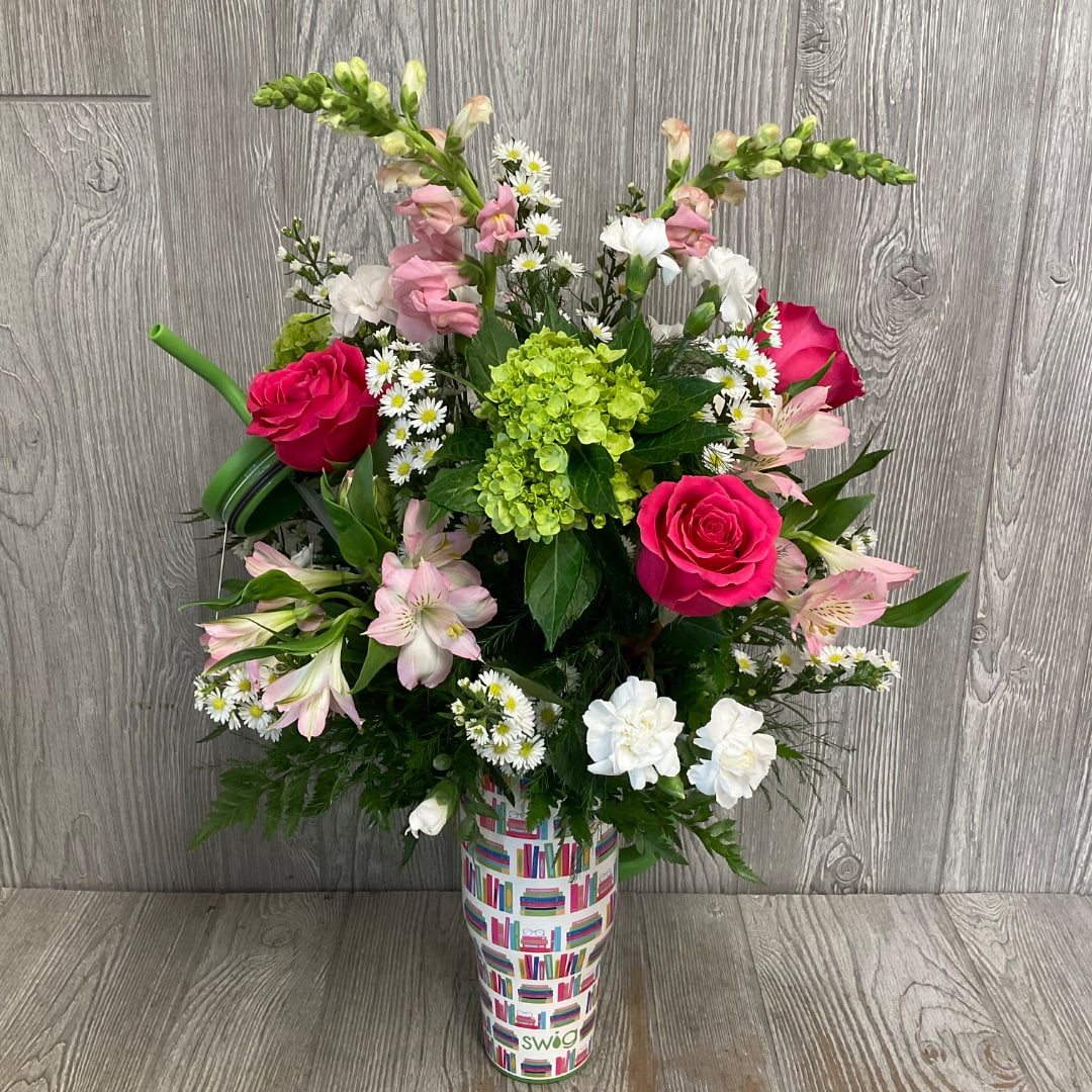 Mixed bouquet with pink roses, white daisies, and green hydrangea in a printed vase