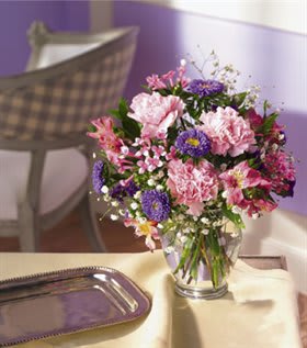 Pink and purple mixed bouquet in a clear glass vase