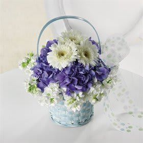 Purple and white flowers arranged in a light blue basket