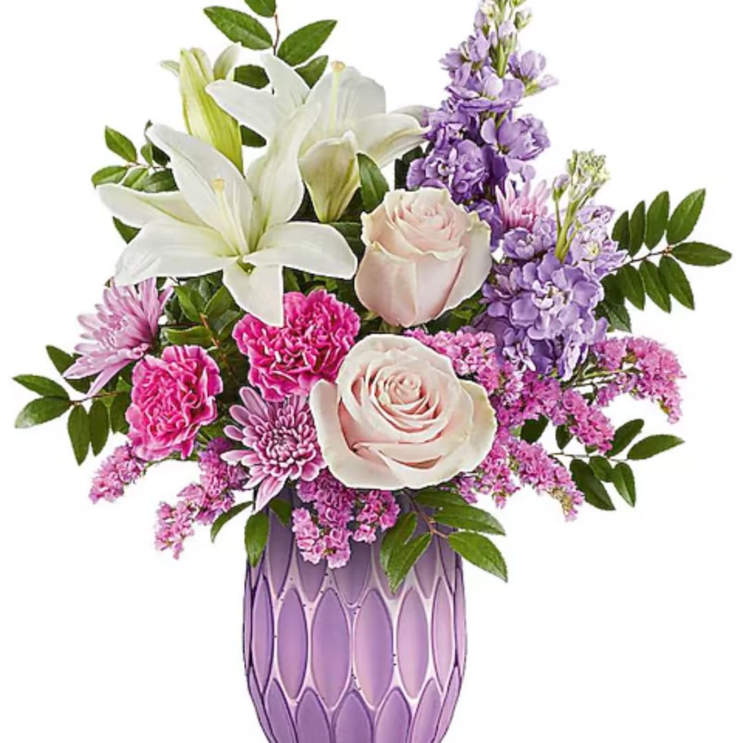 Pink and white floral arrangement in a purple vase