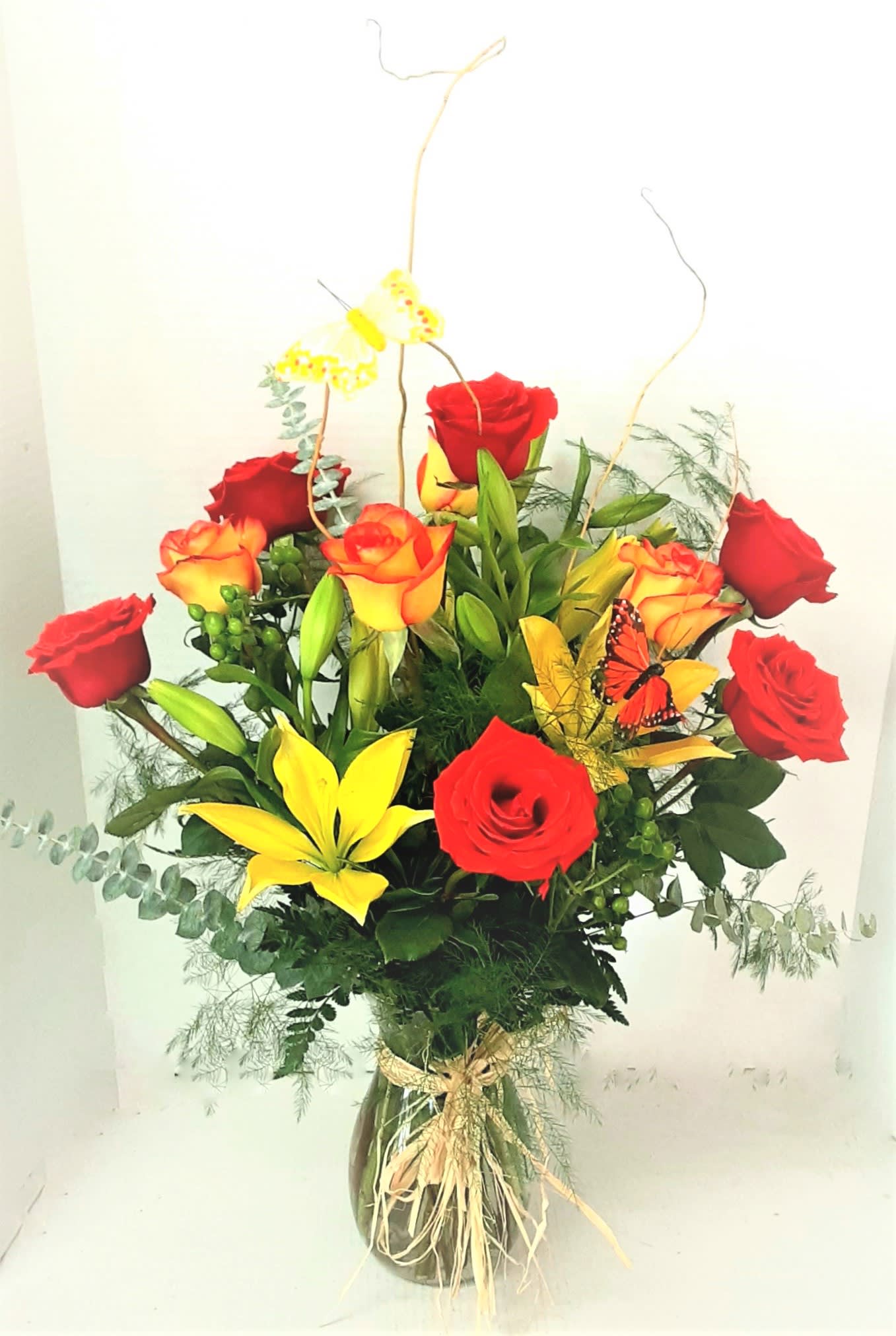 Fall Glory - This fall beauty is full of roses ,lilies, eucalyptus, and butterflies, to warm any ones heart for the fall season.