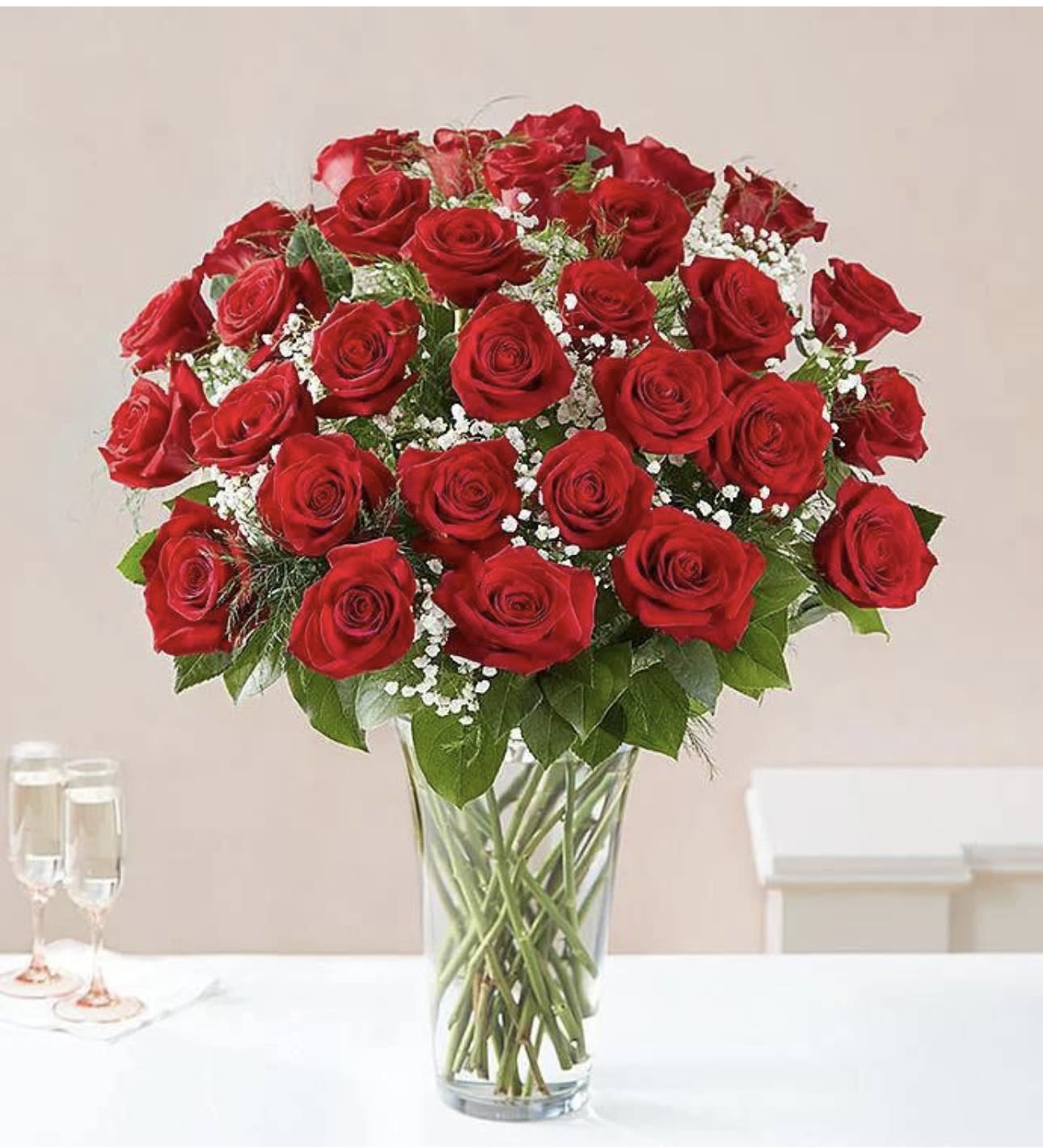 Grandeur Long Stem Rose Arrangement by BloomNation™ - Go big with your love. Send the most extravagant 4 dozen red rose arrangement for Valentine's day, anniversary celebrations, or declarations of love. This luxury arrangement makes a big statement of "I love you" in 50 roses.  Approximate Dimensions: 20"D x 32"H