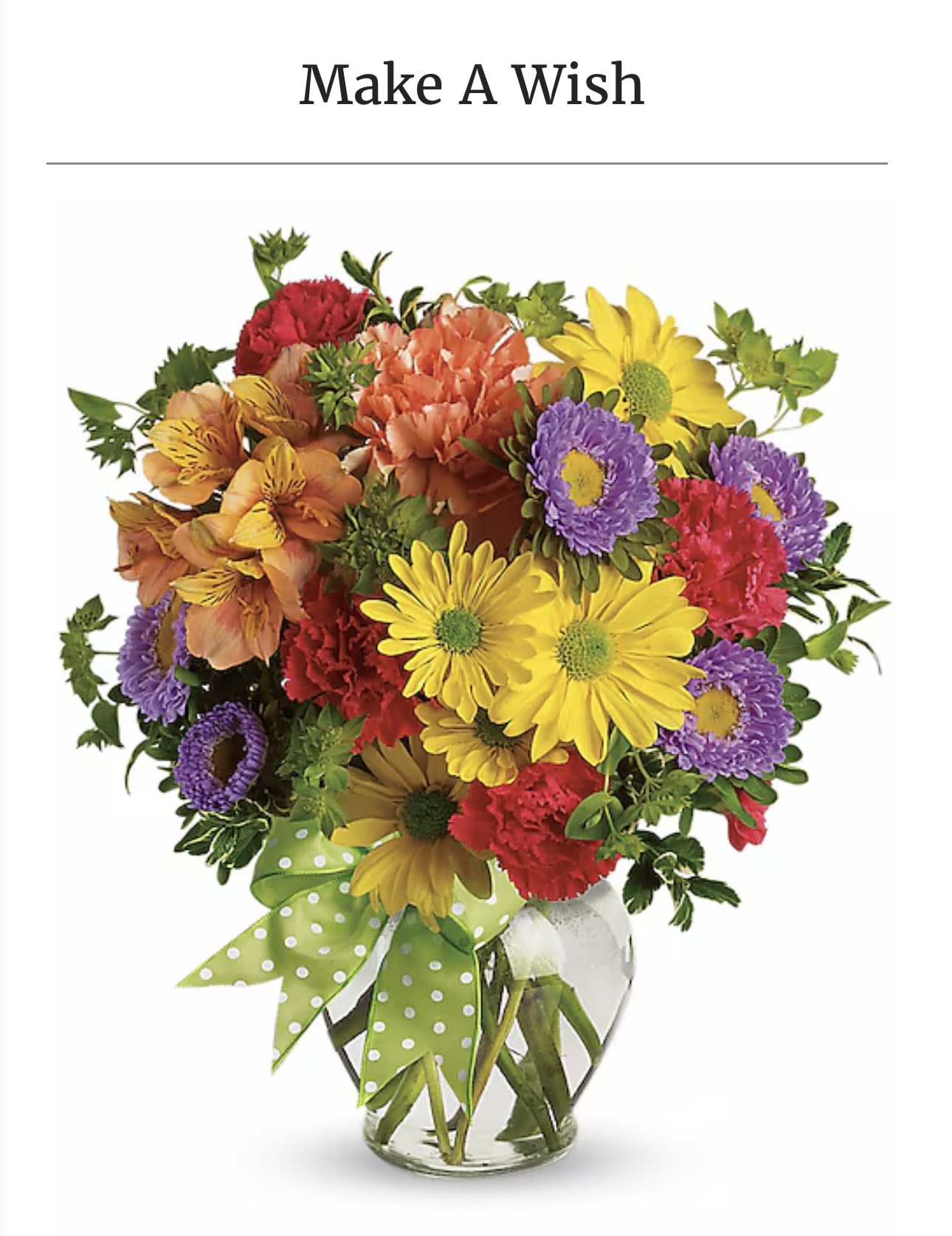 Colorful mixed bouquet in a clear glass vase with a green polka-dot ribbon