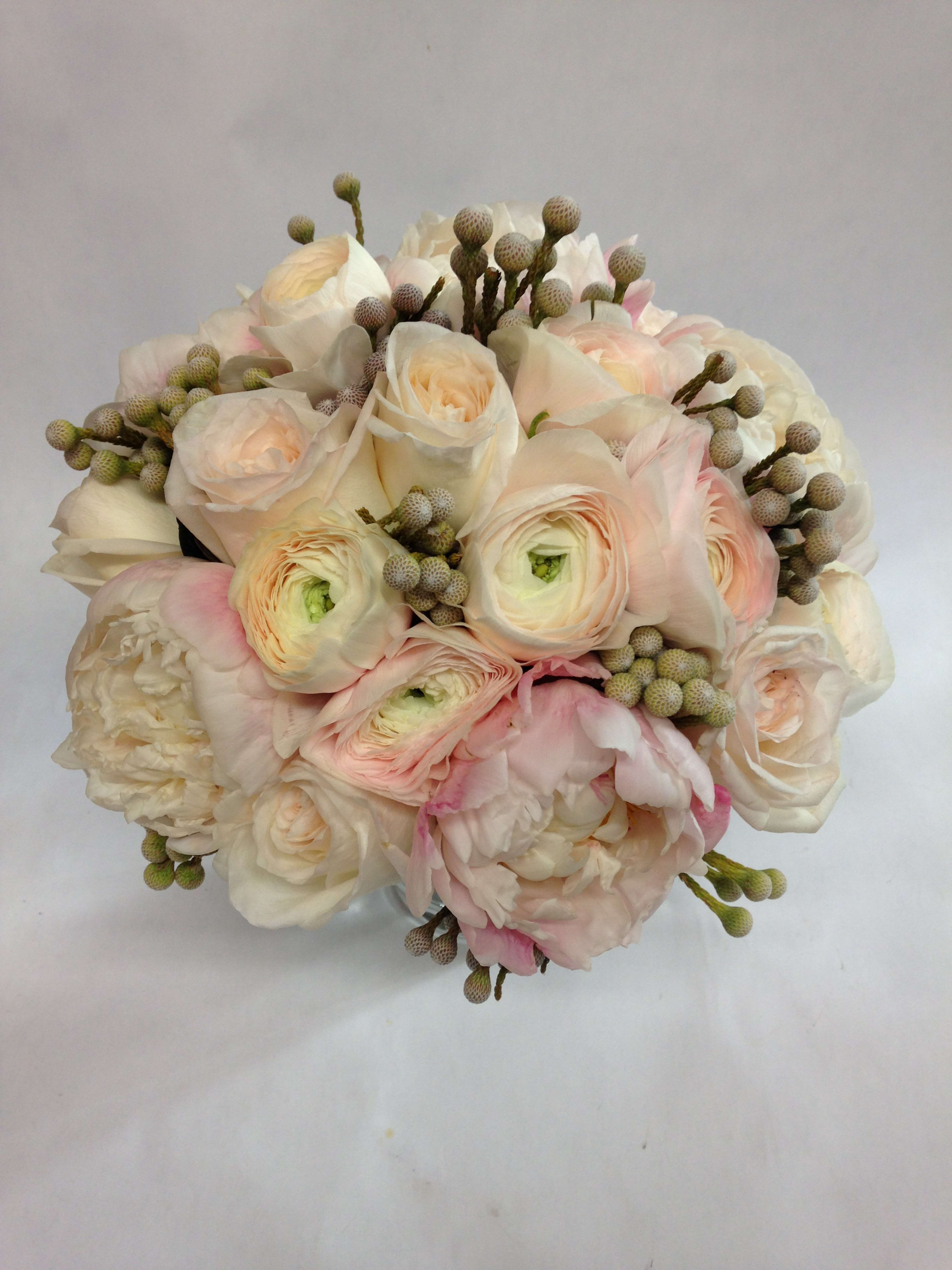Blushing Bridal Bouquet (Pre-order) - This delicate and tender bridal bouquet comes complete with fresh ranunculus, peonies (seasonal), and varying berries (winterberry or hypericum, depending on the season).  (Some flowers may be subject to change depending on the season. We will contact you with available flower substitutions; please contact us with specific questions if you are concerned with flower availability, thanks!)  Featured arrangement: 325.00 (Regular  Price)
