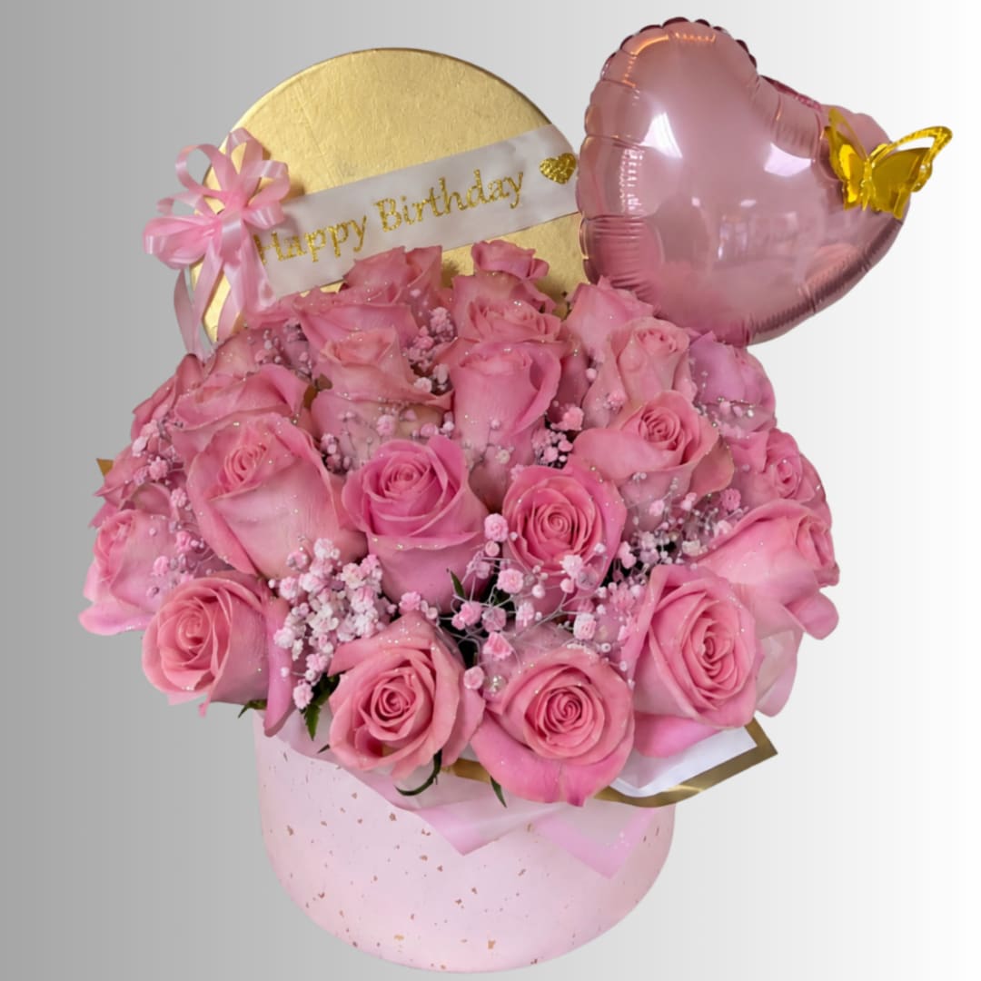Pink rose bouquet in a round gift box with a birthday banner and heart balloon