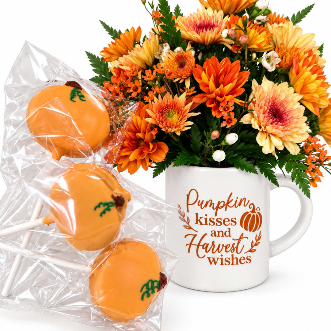 Orange and yellow flower arrangement in a mug with pumpkin cake pops
