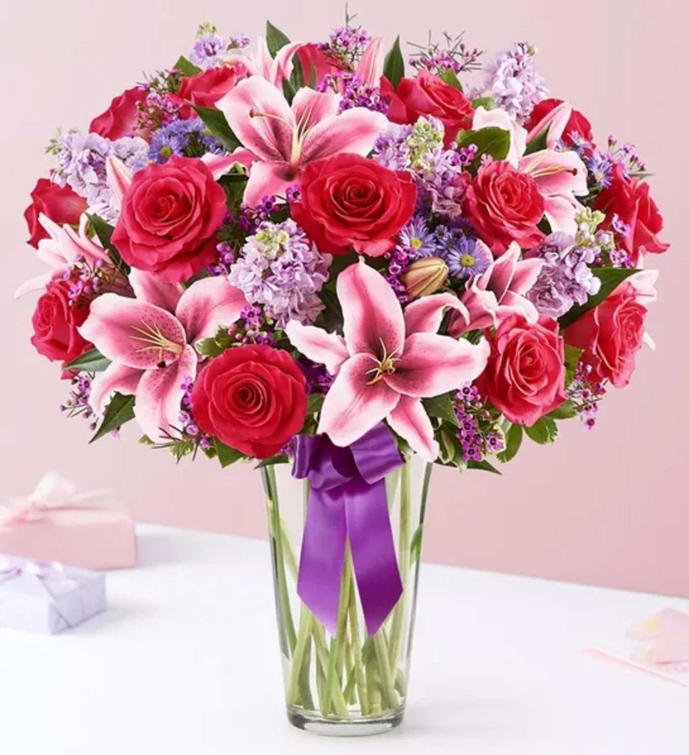 Straight From The Heart - A gift means so much more when it comes from the heart. Our Valentine’s bouquet delivers on that sentiment, with radiant pink and purple blooms arranged in a glass vase. Finished with a purple satin ribbon, it’s a surprise that speaks volumes about how you feel.