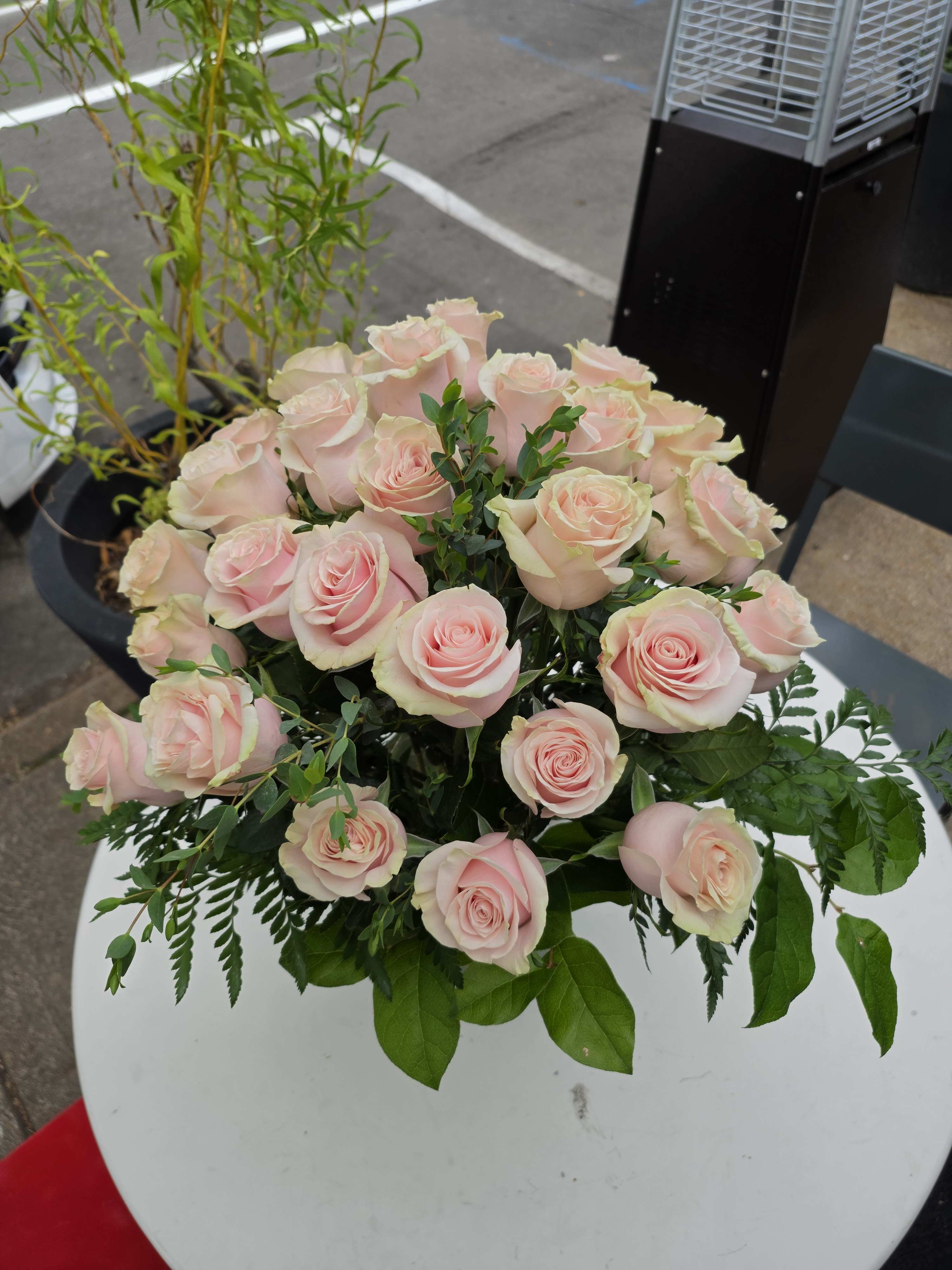 Bouquet of pale pink roses with greenery