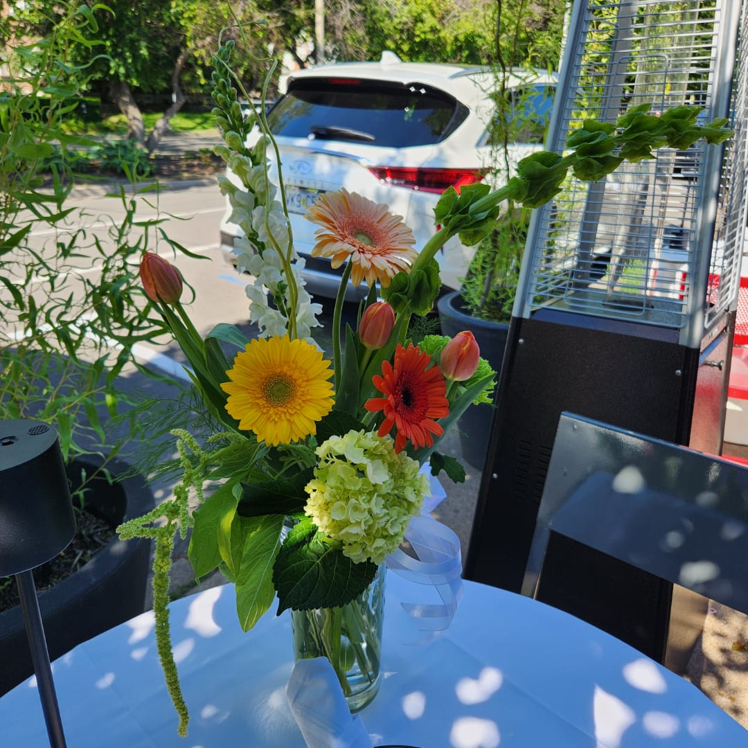 Mixed bouquet in a glass vase with gerbera daisies and tulips