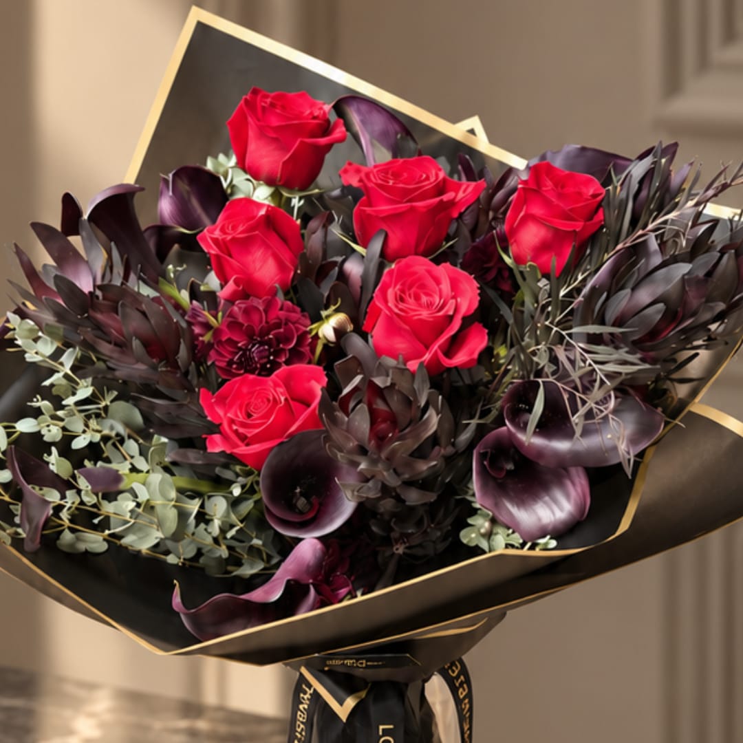 Bouquet of red roses with dark purple flowers and black wrap