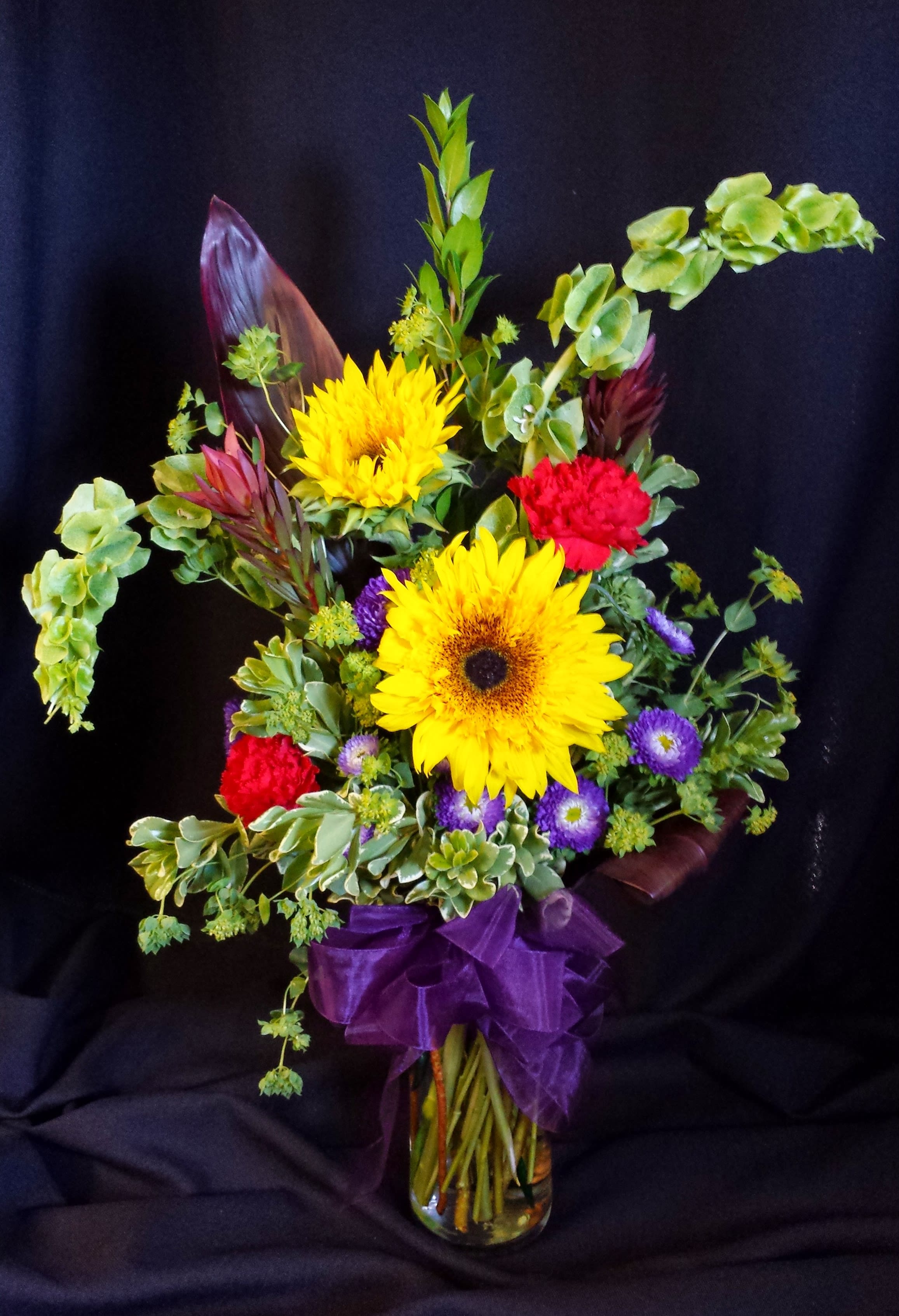 Birthday bright bouquet small Cylinder - Selection will vary depending on the season. Bright mix of fun birthday best flowers in a simple glass cylinder vase.