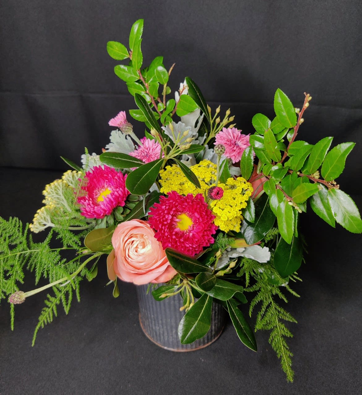 Smallest Budvase Event Centerpiece  - Just a handful of seasonal flowers and a nice assortment of foliage in a small container. Container will vary and can be glass, metal, wood, resin, plastic or other. If you are planning an event and providing a few week's notice, we can special order containers of your choosing. 