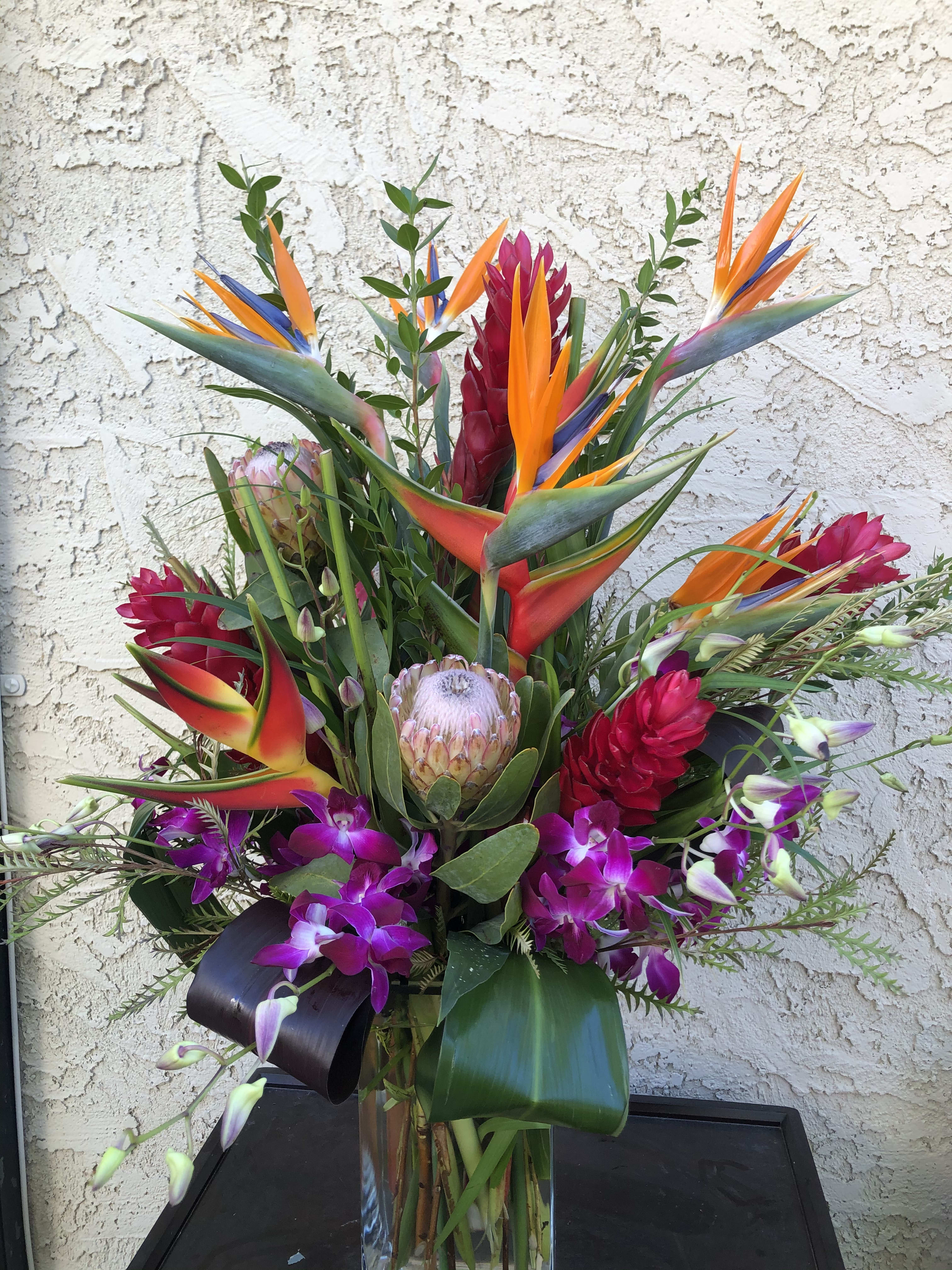 Tropical Breezes - Haleconia, Birds of Paradise, Protea, dendrobium orchid and tropical foliage will make anyone feel like they’re in the tropics!