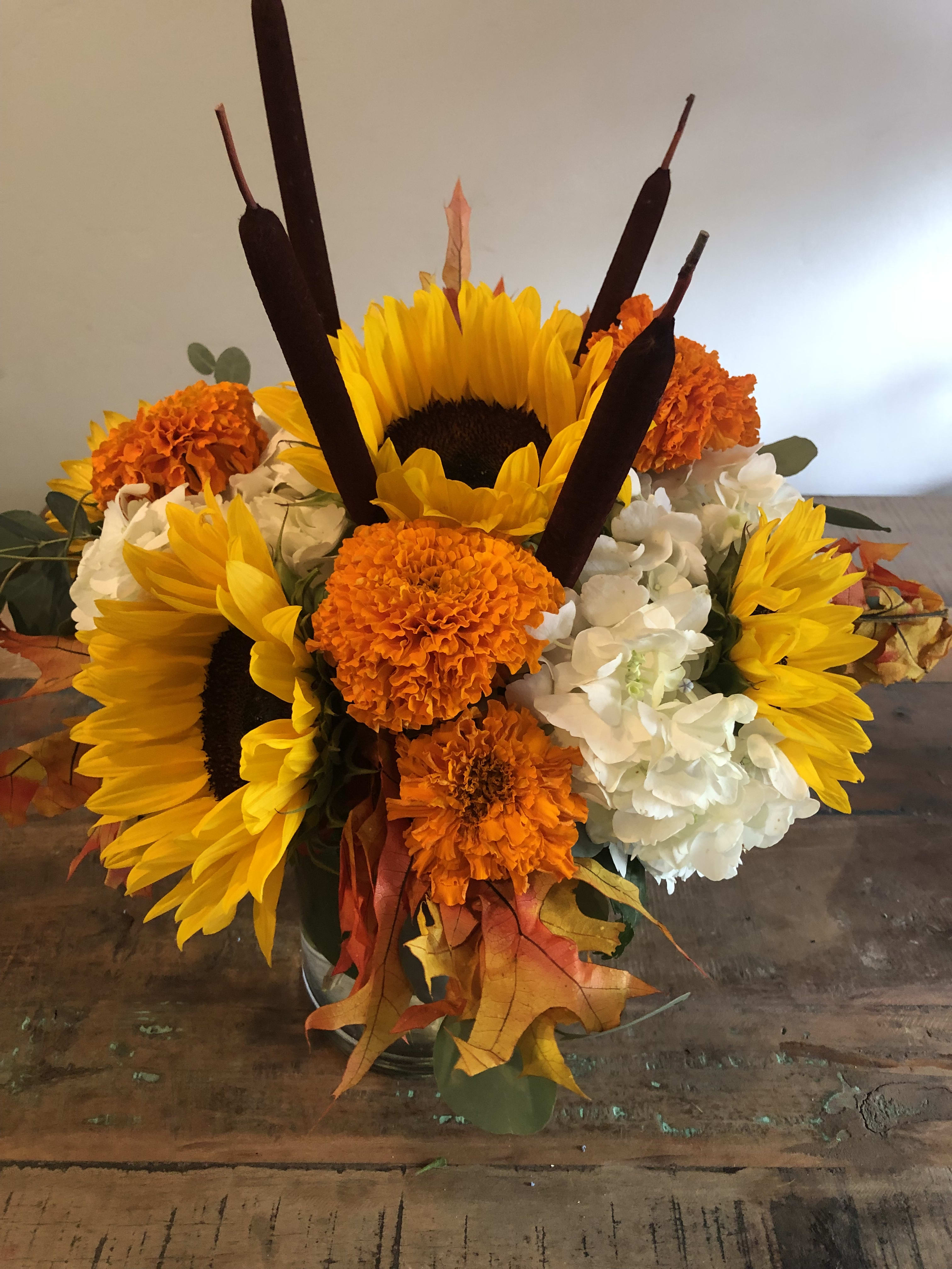Fall Bounty - White hydrangea, marigolds, sunflowers, fall leaves, and cattails 
