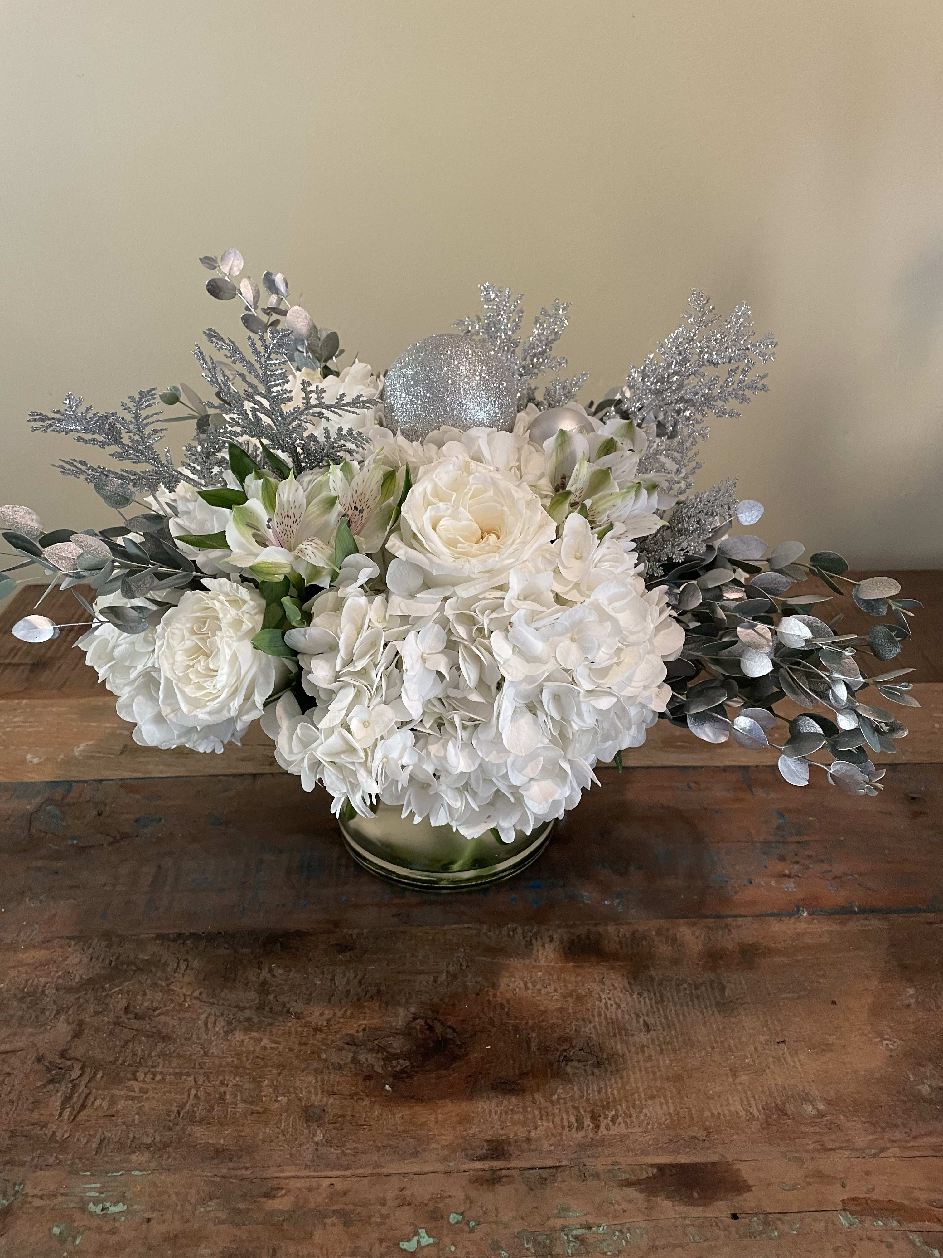 Silver bells - White hydrangea, white roses and silver adornments will add sparkle to anyone’s table. 