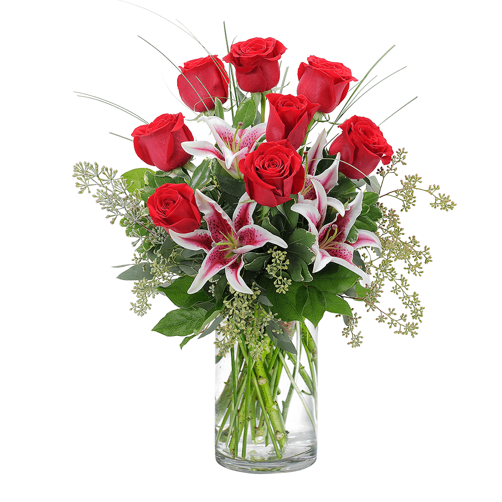 Red roses and pink lilies in a clear glass vase