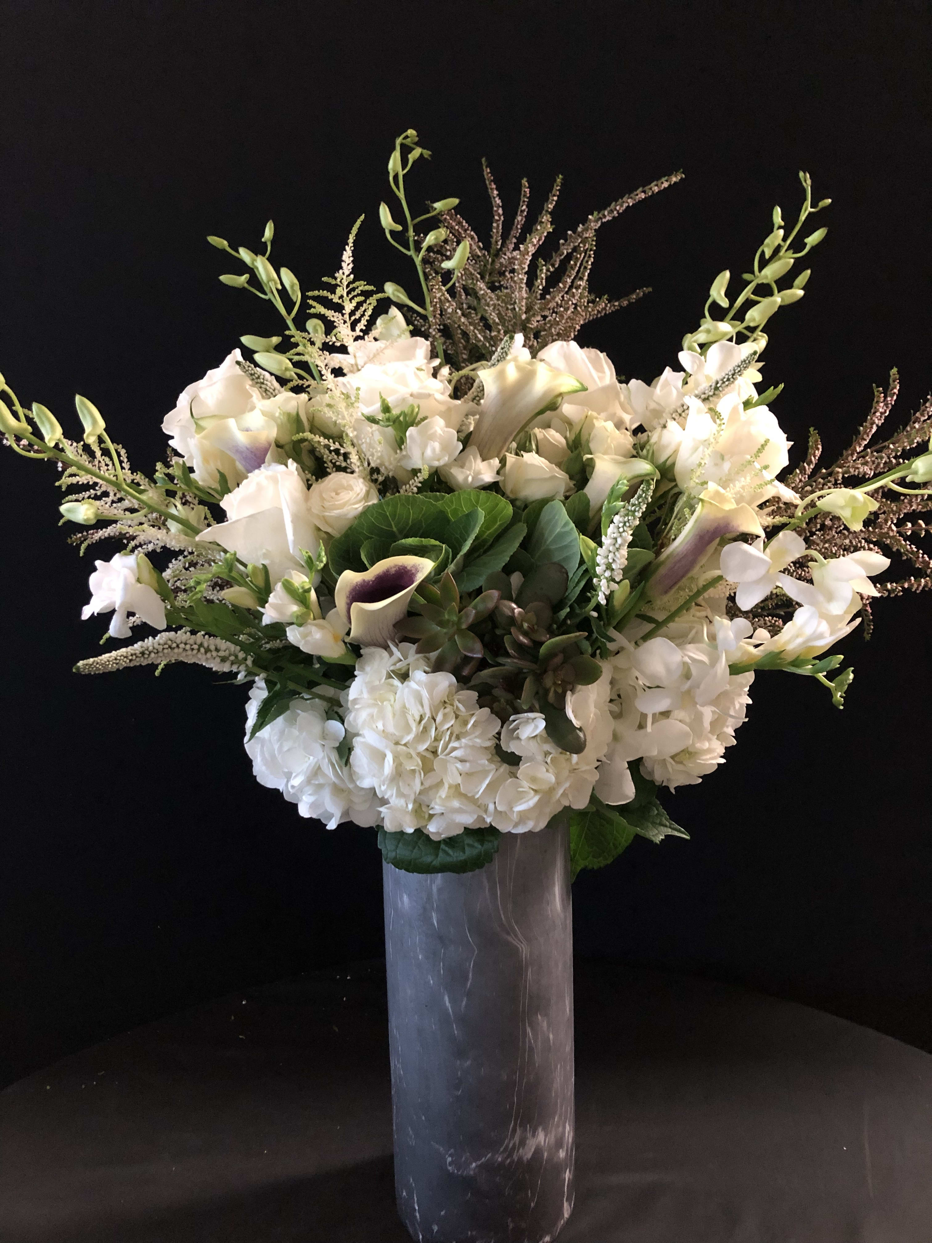 A beautiful life. - Our Stunning all white tall beauty is one of the most popular and elegant pieces.  We add a beautiful succulent as the final touch. Vase will vary! The grey ceramic will be part of the $300- upgrades require bigger vases which may be clear glass, silver or grey. 