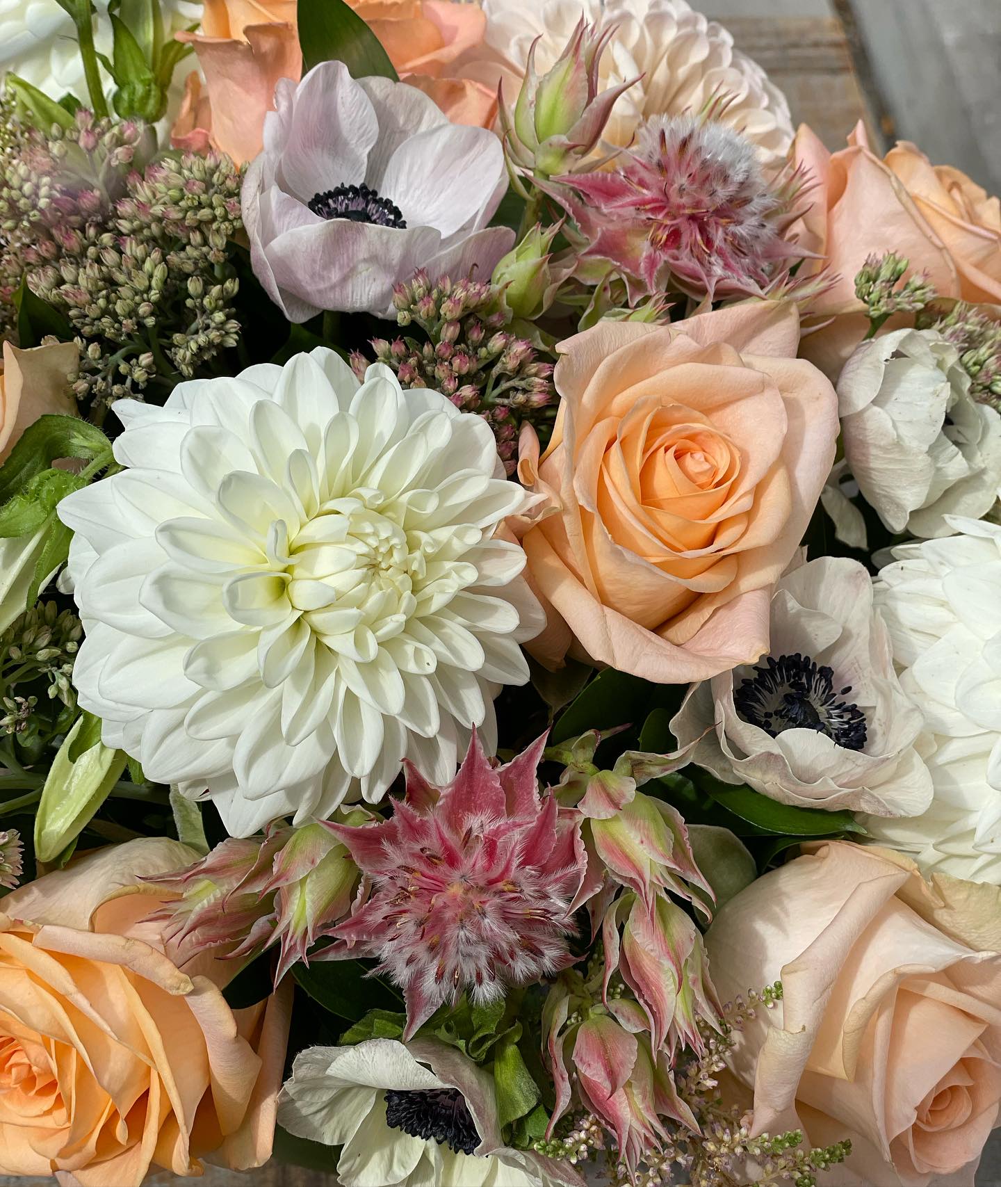 Bouquet of peach roses and white flowers with pink accents