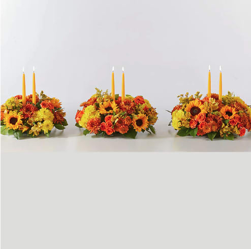Autumn Harmony Centerpiece  - AUTUMN HARMONY CENTERPIECE BY FTD  Enjoy a candlelit dinner with this colorful arrangement that embraces every shade of fall.  Please Note: The centerpiece pictured reflects the original design for this product. While we always try to follow the color palette, we may replace stems to deliver the freshest bouquet possible, and we may sometimes need to use a different candle.