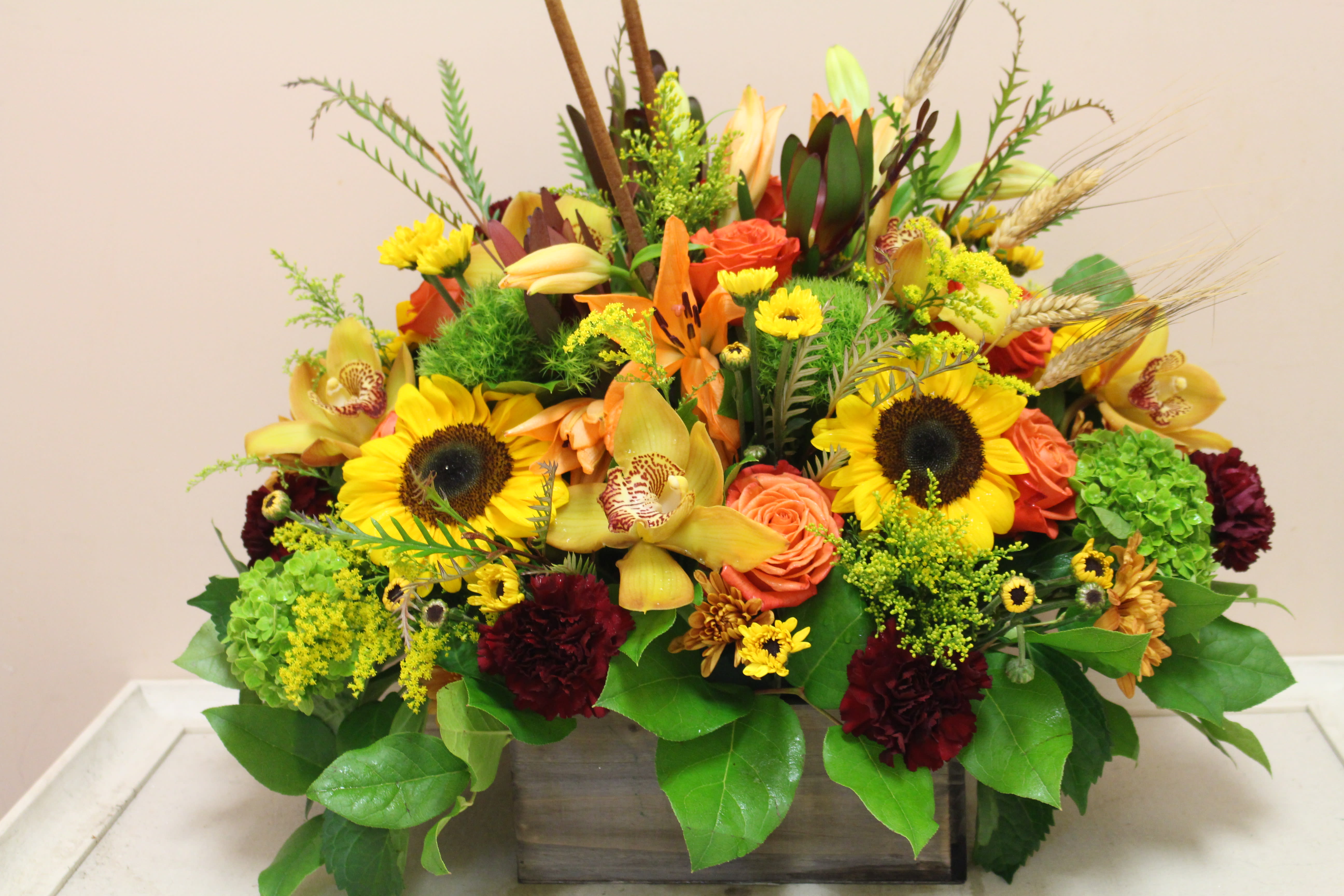sunny days ahead - this wooden box is filled to the brim with an autumn arrangement.  Bursting with color this is a sure showstopper!