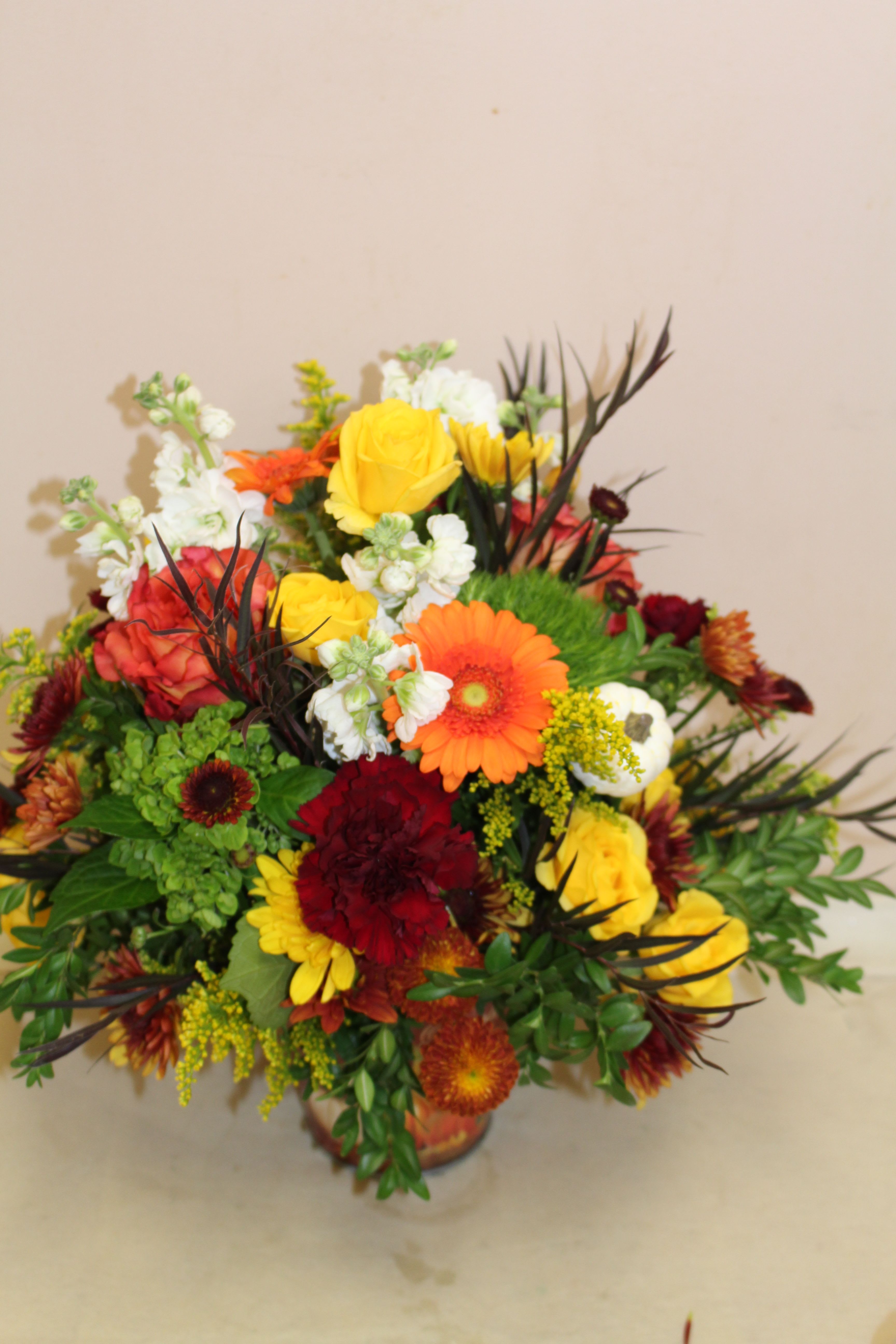 Pumpkin patch tin - A festive autumn arrangement filled with an array of flowers including gerberas, roses and carnations.  Long lasting and sure to please