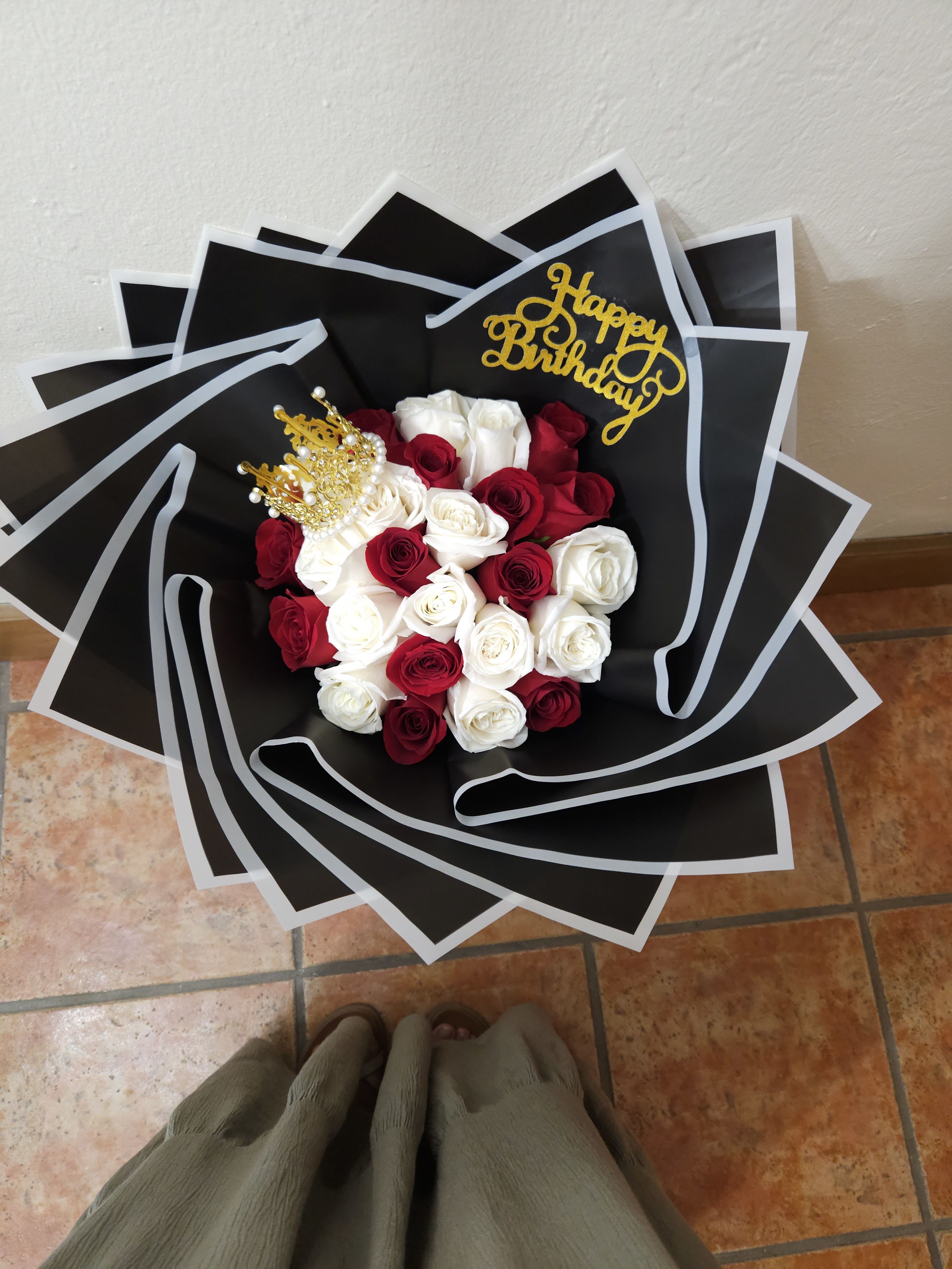 Bouquet of red and white roses with a gold birthday topper