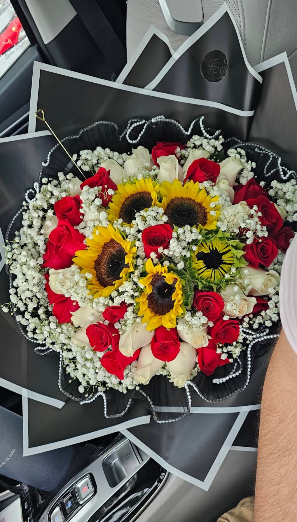 Bouquet of red and white roses with sunflowers and baby's breath