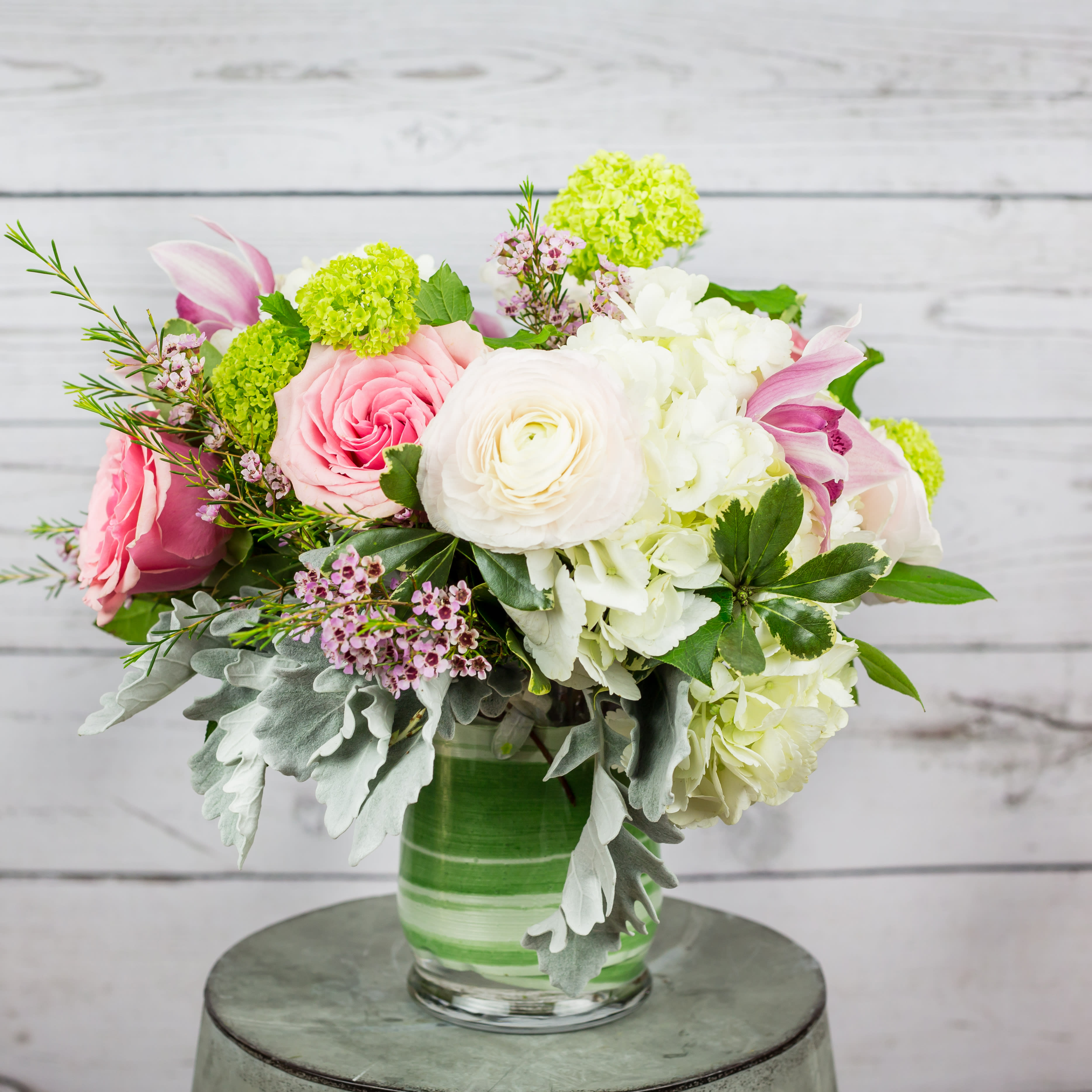 Pink and white mixed flower arrangement in a glass vase
