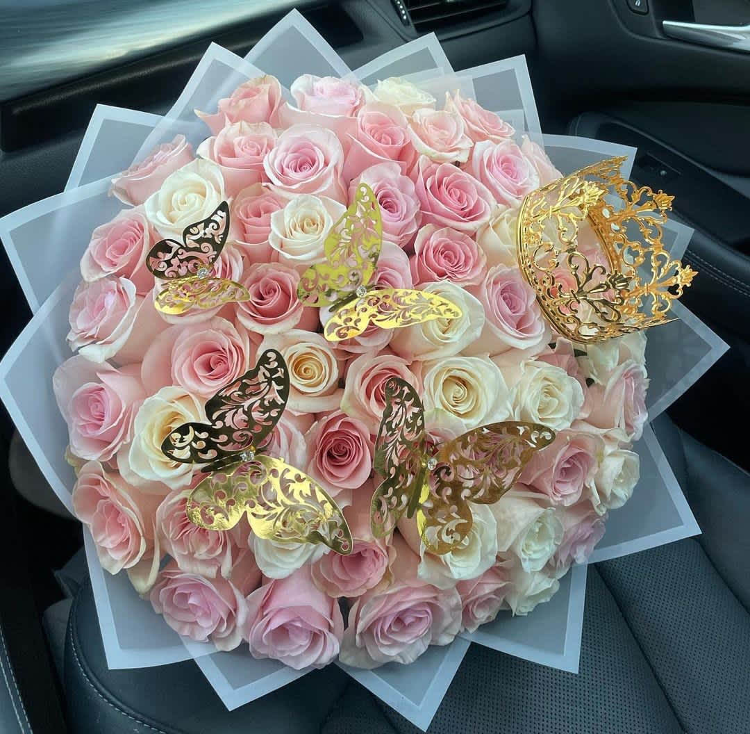 Bouquet of pink and white roses with gold butterfly decorations