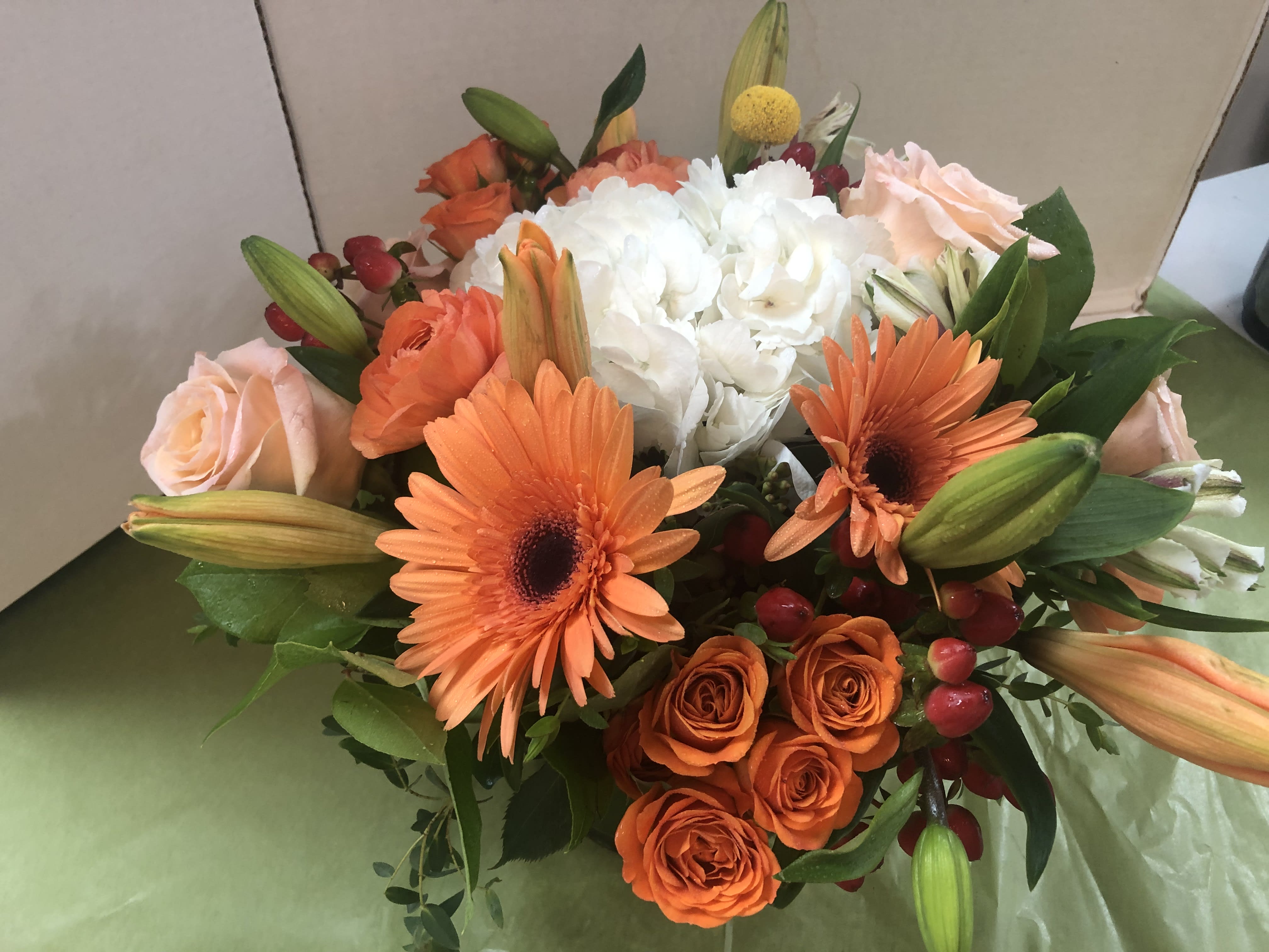 Bouquet of orange and white flowers with pale pink roses