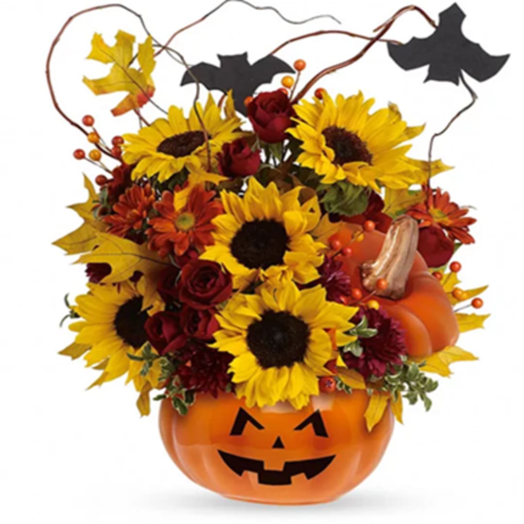 Halloween arrangement in a jack-o'-lantern pumpkin container with sunflowers and roses