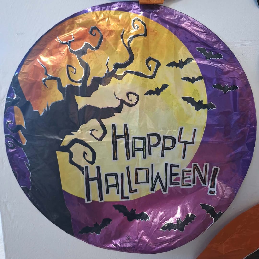 Round Halloween balloon with bats and a spooky tree, reading Happy Halloween