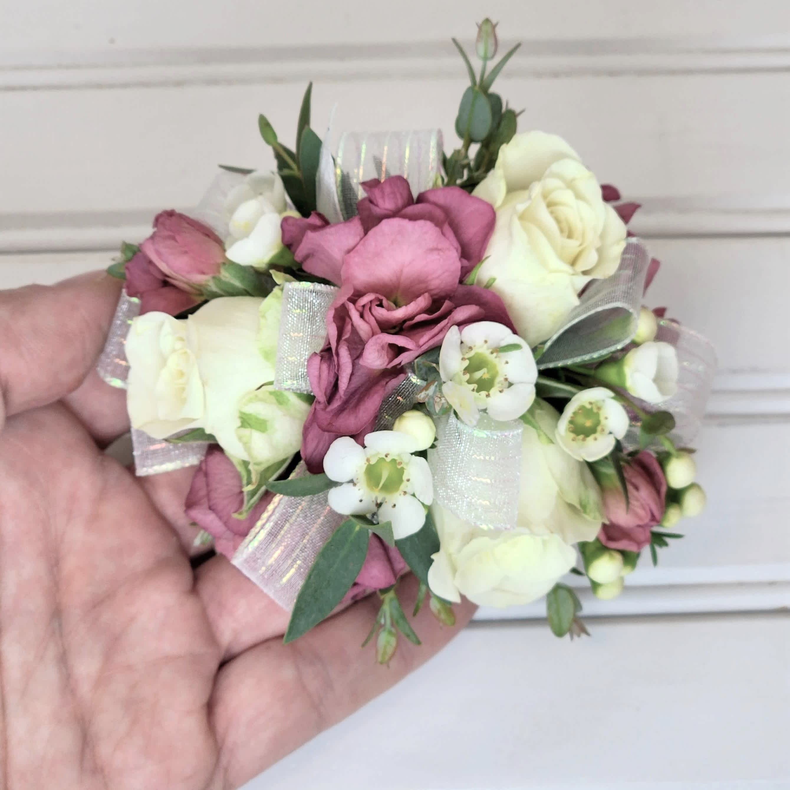 Small pink and white floral corsage with ribbon