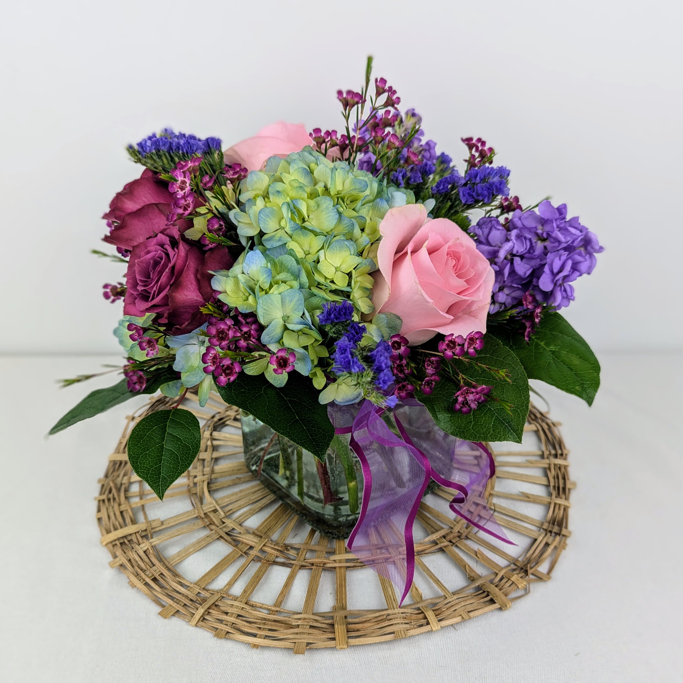Spring Fling - This arrangement includes roses, hydrangea, stock and filler flowers in a clear cube vase. Spring Fling is a great gift for a birthday, get well, or just because. 