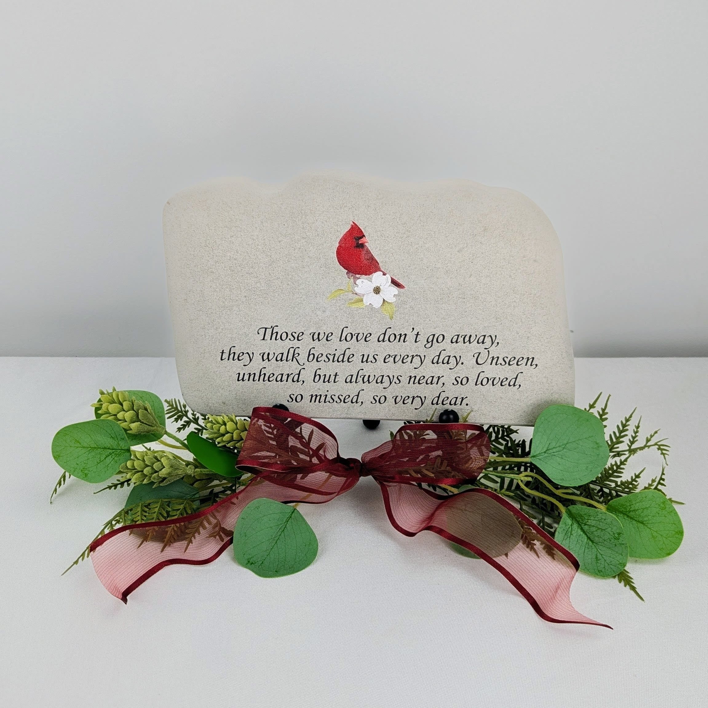 Memorial stone with a red cardinal and floral decoration