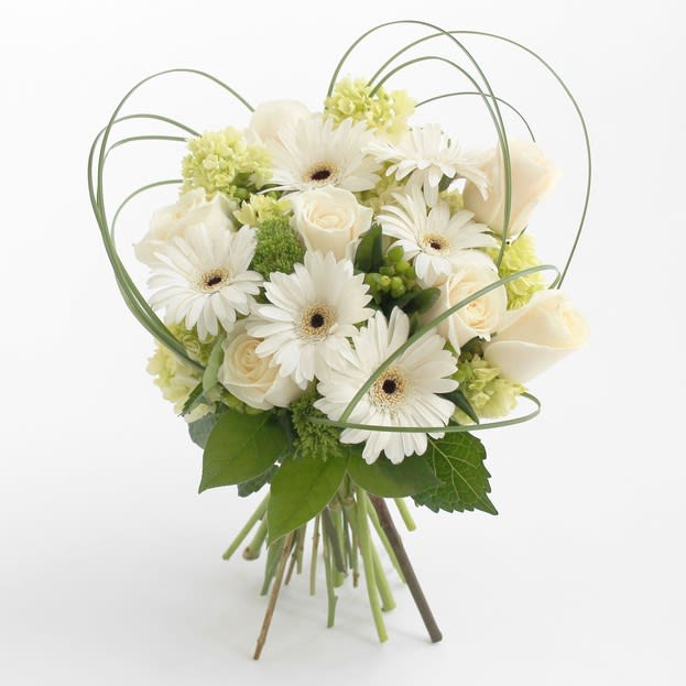 White gerbera daisies and roses in a hand-tied bouquet