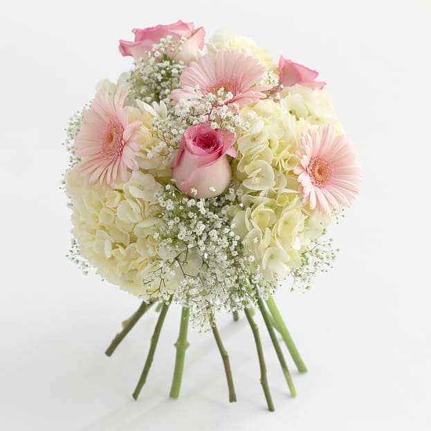 Bouquet of pink and cream flowers with a central rose
