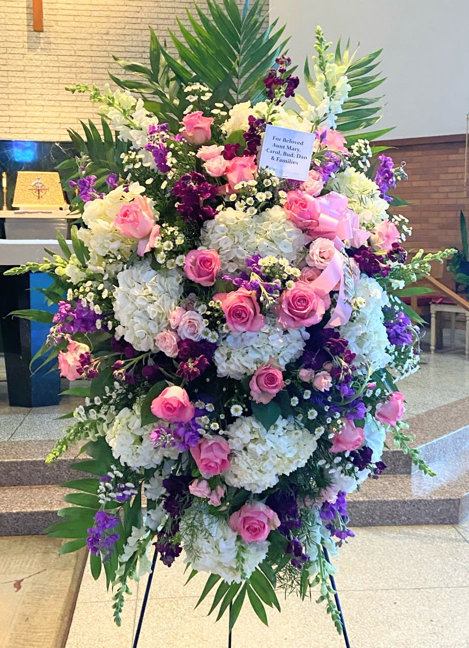 Large standing floral spray with pink roses, white hydrangeas, and purple flowers