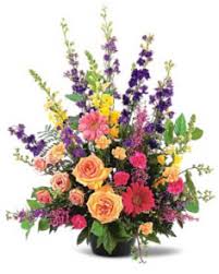 Mixed bouquet with roses and tall purple flowers in a vase